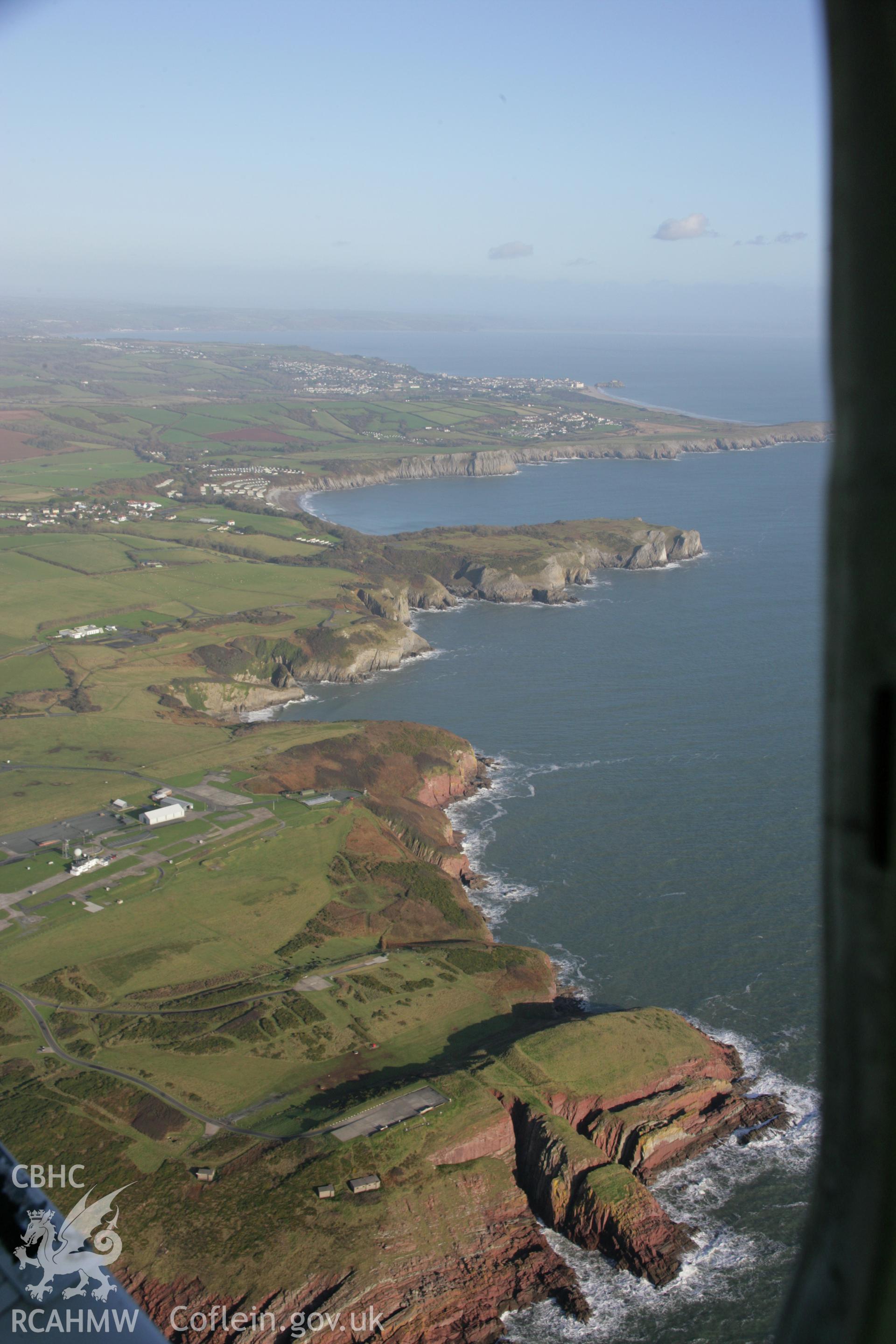 RCAHMW colour oblique aerial photograph of Old Castle Head Promontory Fort, in landscape view looking north-east towards Shrinkle Haven. Taken on 11 January 2006 by Toby Driver.