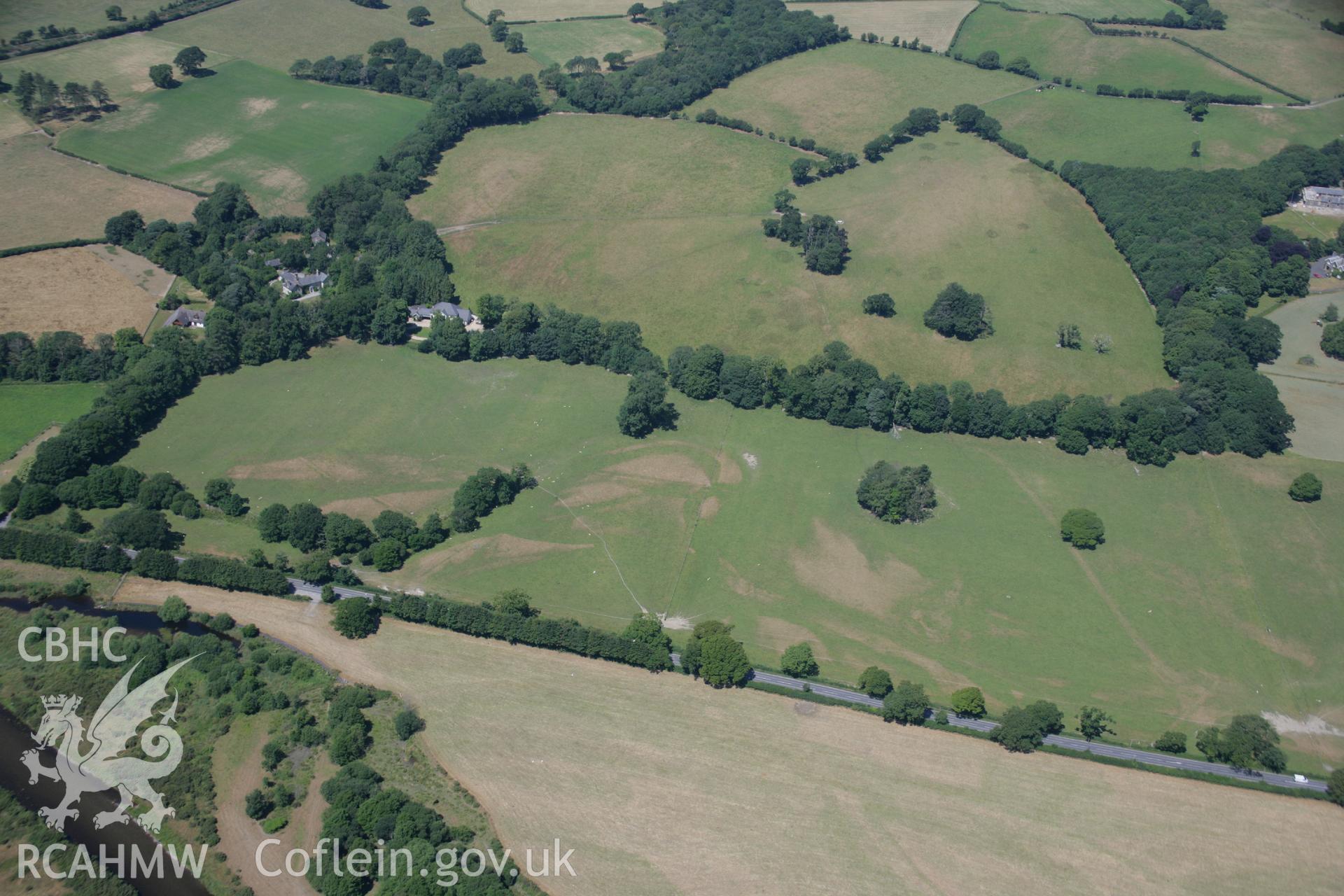 RCAHMW colour oblique aerial photograph showing parchmarks near Dolau Garden. Taken on 17 July 2006 by Toby Driver.