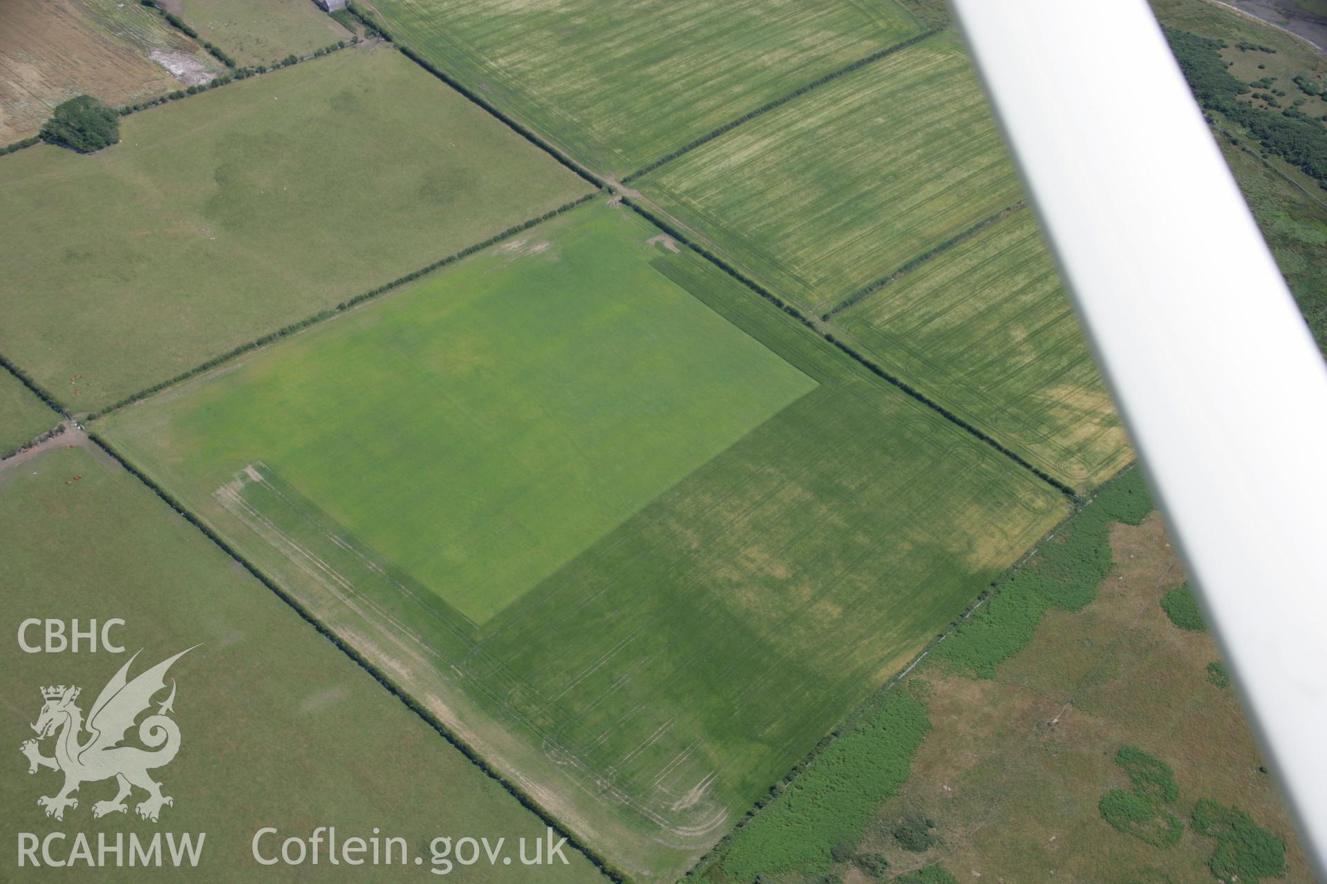 RCAHMW colour oblique aerial photograph of Rhuddgaer Romano-British Settlement, Dwyran. Taken on 18 July 2006 by Toby Driver.