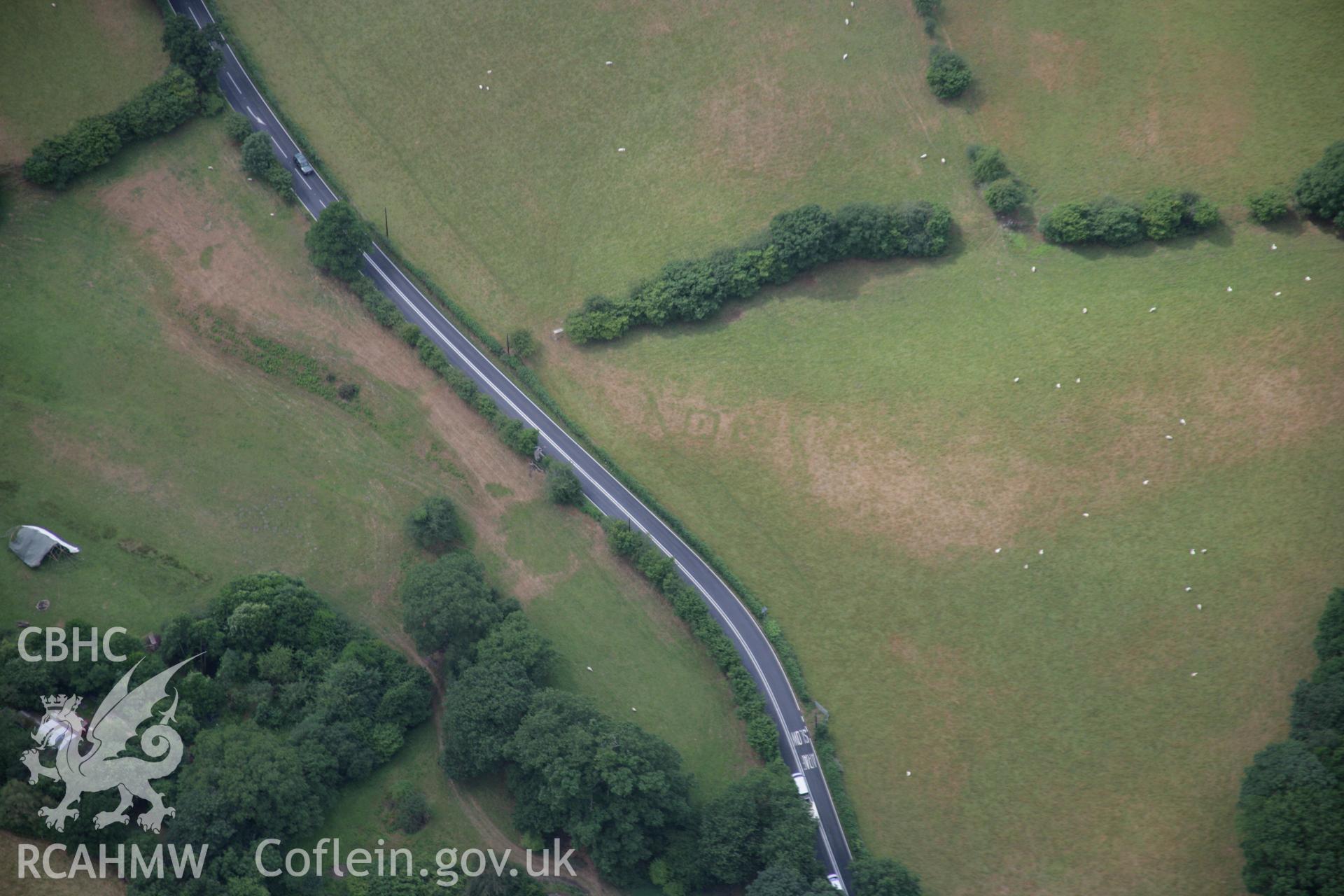 RCAHMW colour oblique aerial photograph of Druid Square Barrows and the Roman road. Taken on 31 July 2006 by Toby Driver.