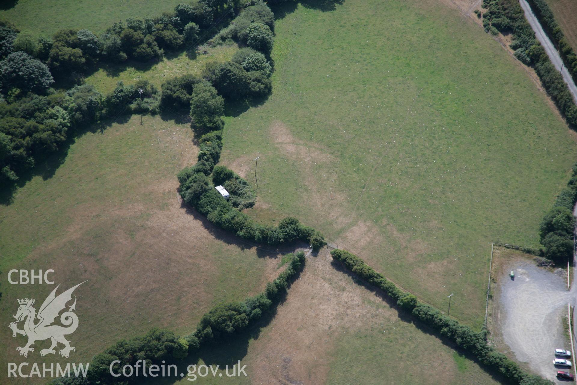 RCAHMW colour oblique aerial photograph of an enclosure to the southwest of St Michael's Church. Taken on 27 July 2006 by Toby Driver.