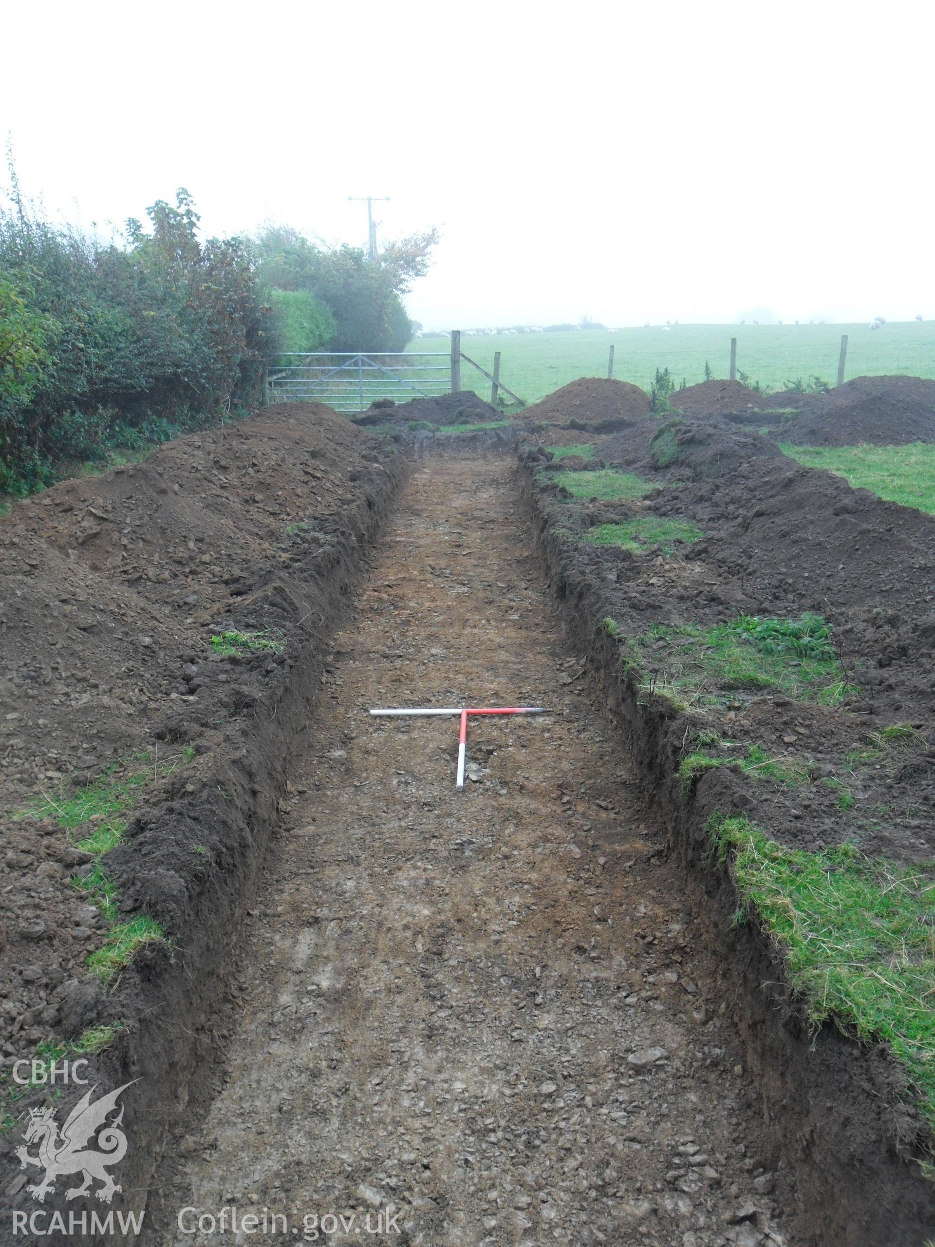 Plate 7: photograph showing view south along trench. Produced as part of Archaeological Desk Based Assessment and Field Evaluation for Llanelian yn Rhos Colwyn Bay, Conwy', report no. 1084. Produced by Archaeology Wales in 2012.