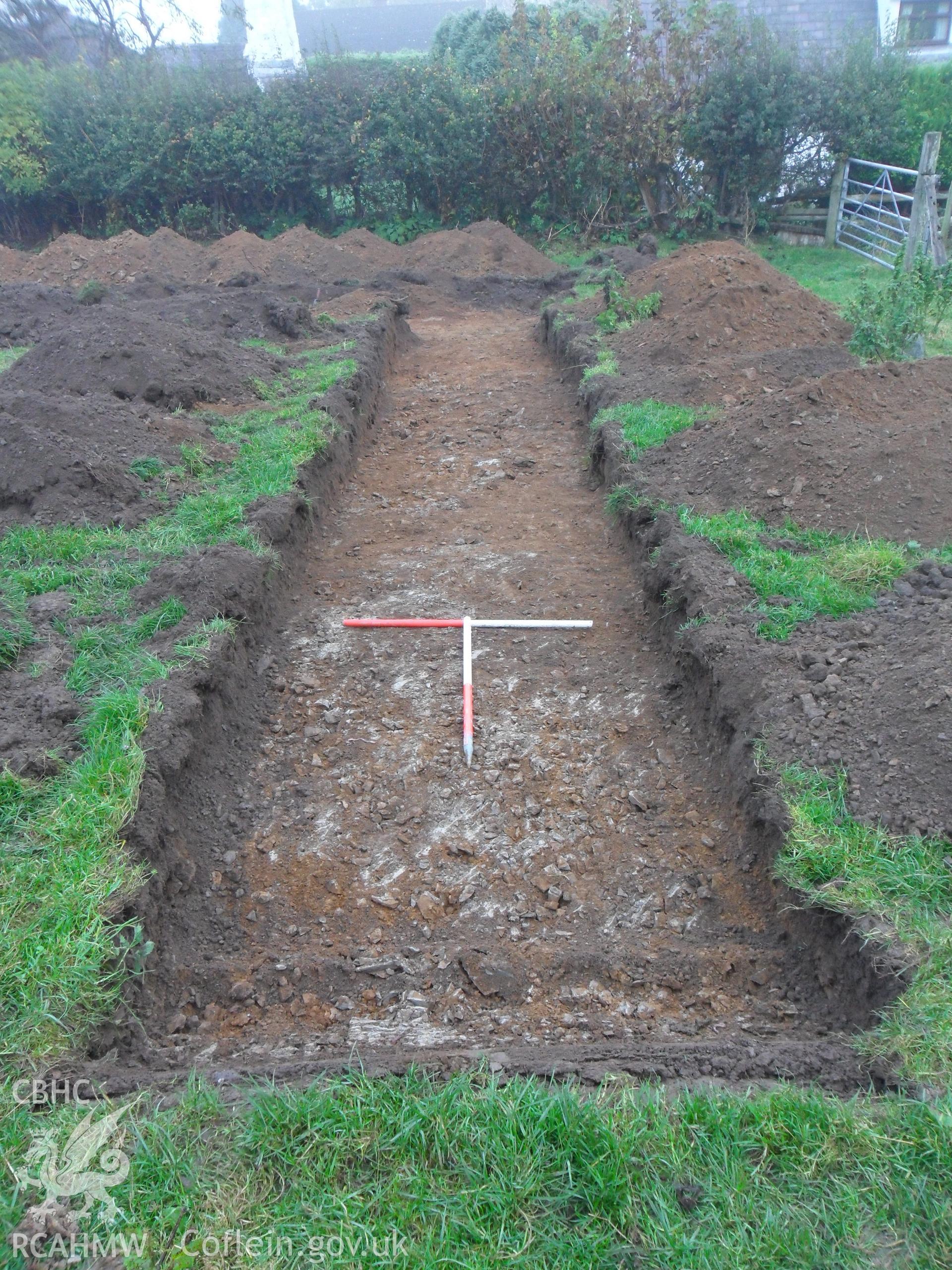 Plate 6: photograph showing view east along trench. Produced as part of Archaeological Desk Based Assessment and Field Evaluation for Llanelian yn Rhos Colwyn Bay, Conwy', report no. 1084. Produced by Archaeology Wales in 2012.