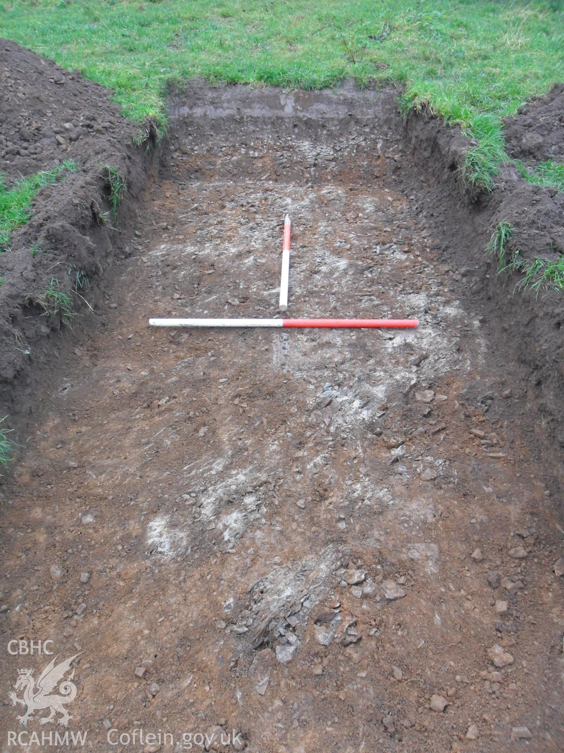 Plate 5: photograph showing view of bedrock within trench. Produced as part of Archaeological Desk Based Assessment and Field Evaluation for Llanelian yn Rhos Colwyn Bay, Conwy', report no. 1084. Produced by Archaeology Wales in 2012.