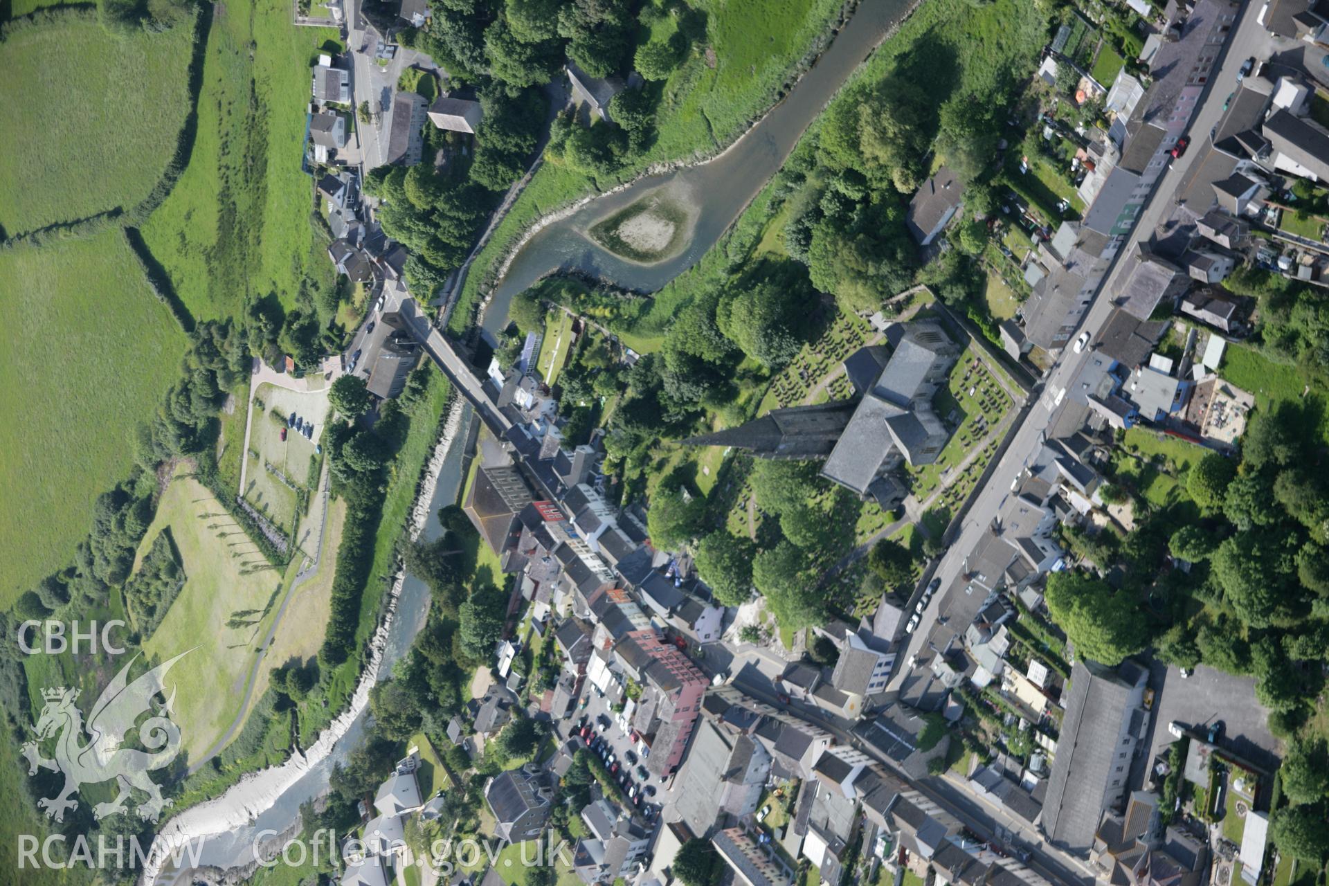 RCAHMW colour oblique aerial photograph of St Mary's Church, Kidwelly (Benedictine Priory), from the south-east. Also showing the town. Taken on 09 June 2005 by Toby Driver