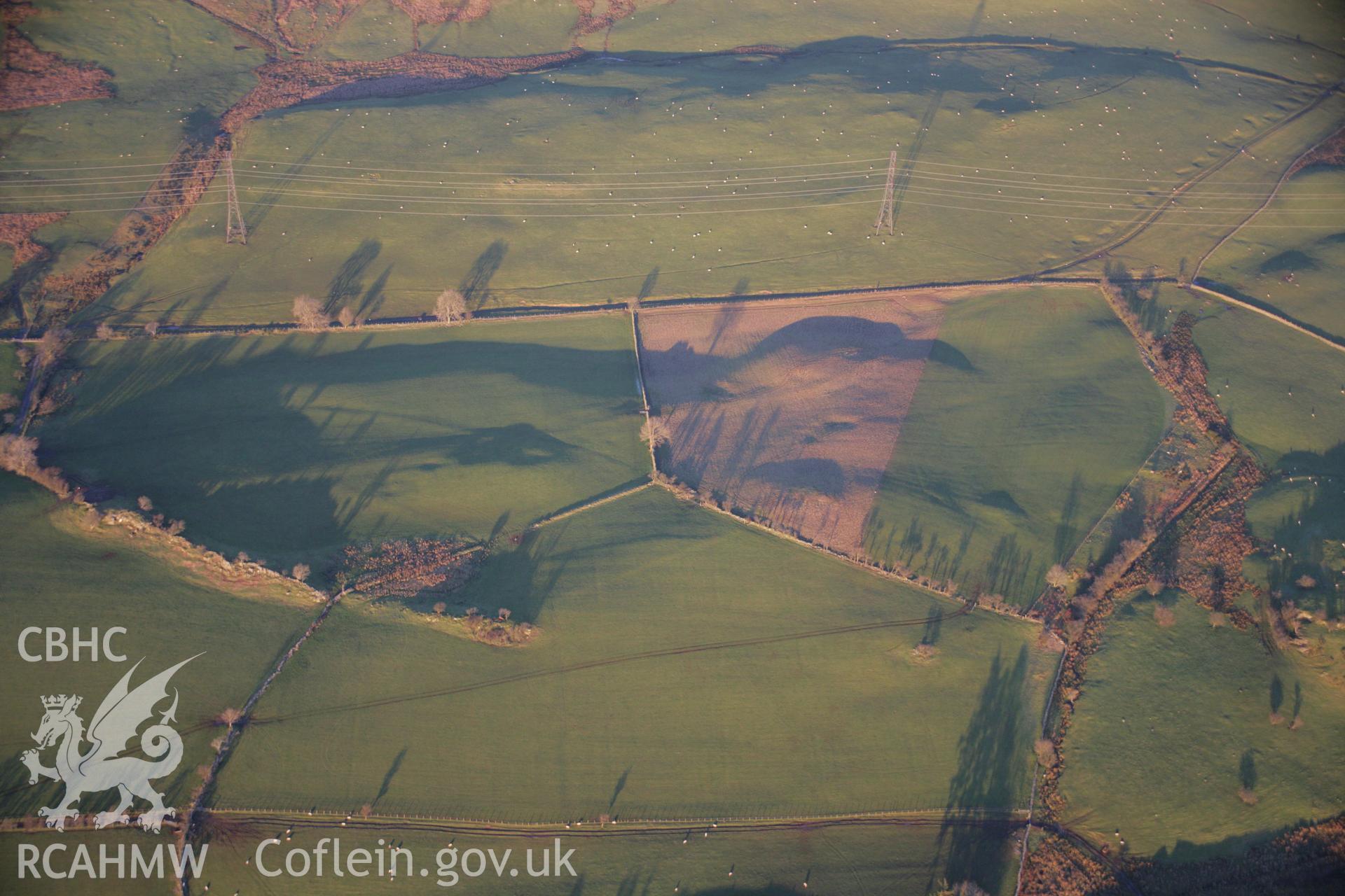 RCAHMW colour oblique aerial photograph of the Roman Road west of Dolbelydr from the south-west. The road shows as a low earthwork. Taken on 21 November 2005 by Toby Driver