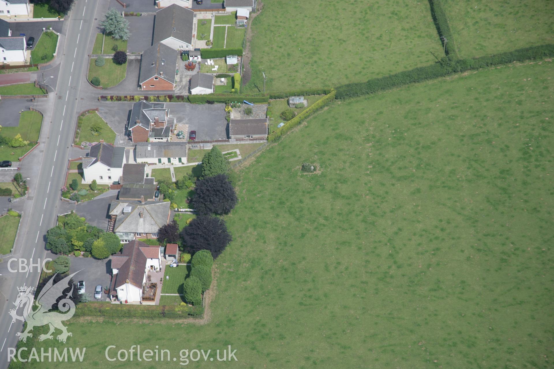 RCAHMW colour oblique aerial photograph of Ffynnon Newydd Henge, with standing stone, from the south. Taken on 11 July 2005 by Toby Driver