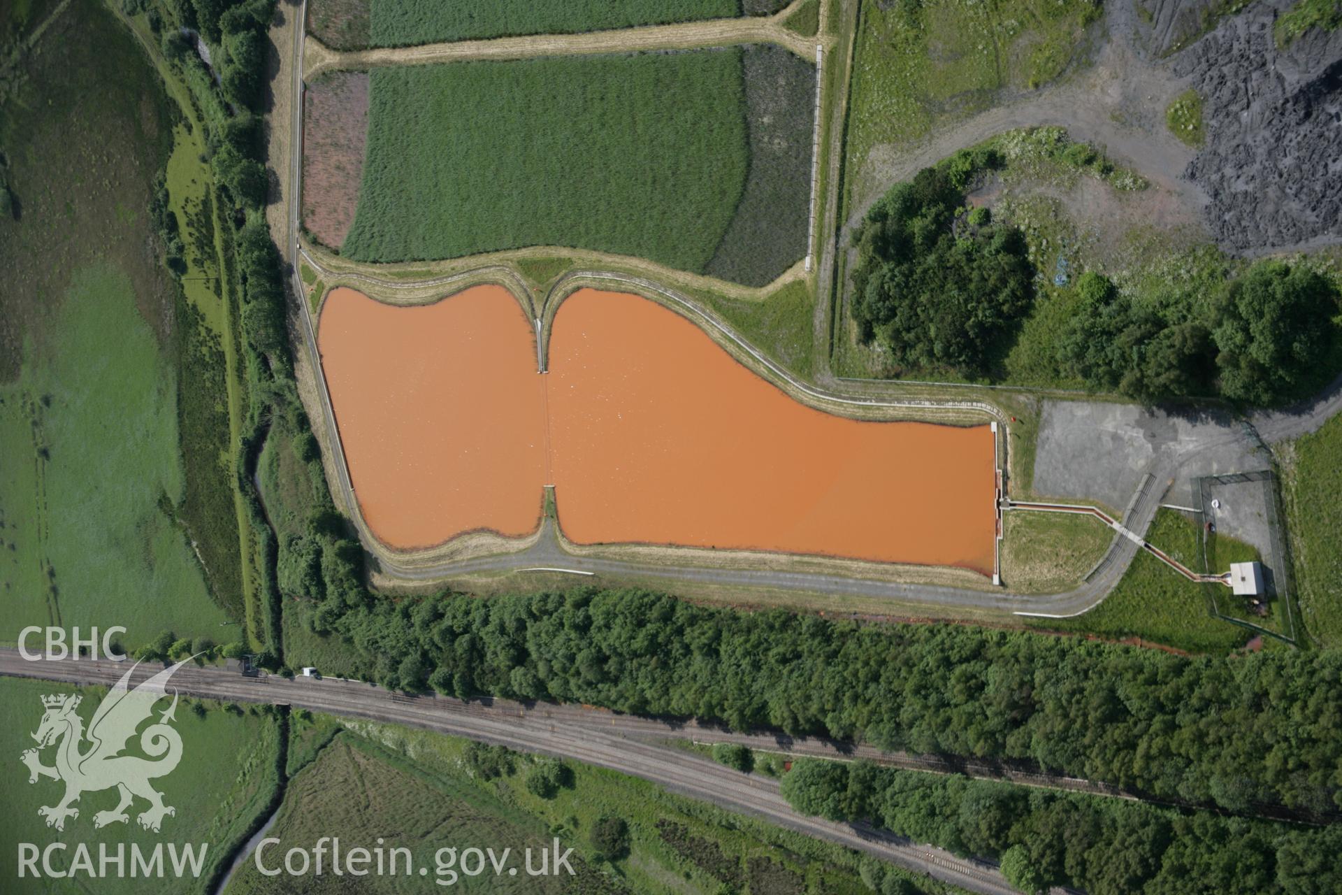 RCAHMW colour oblique aerial photograph of settling tanls at Former Morlais Colliery Winding Engine House, Llangennech, viewed from the north. Taken on 09 June 2005 by Toby Driver