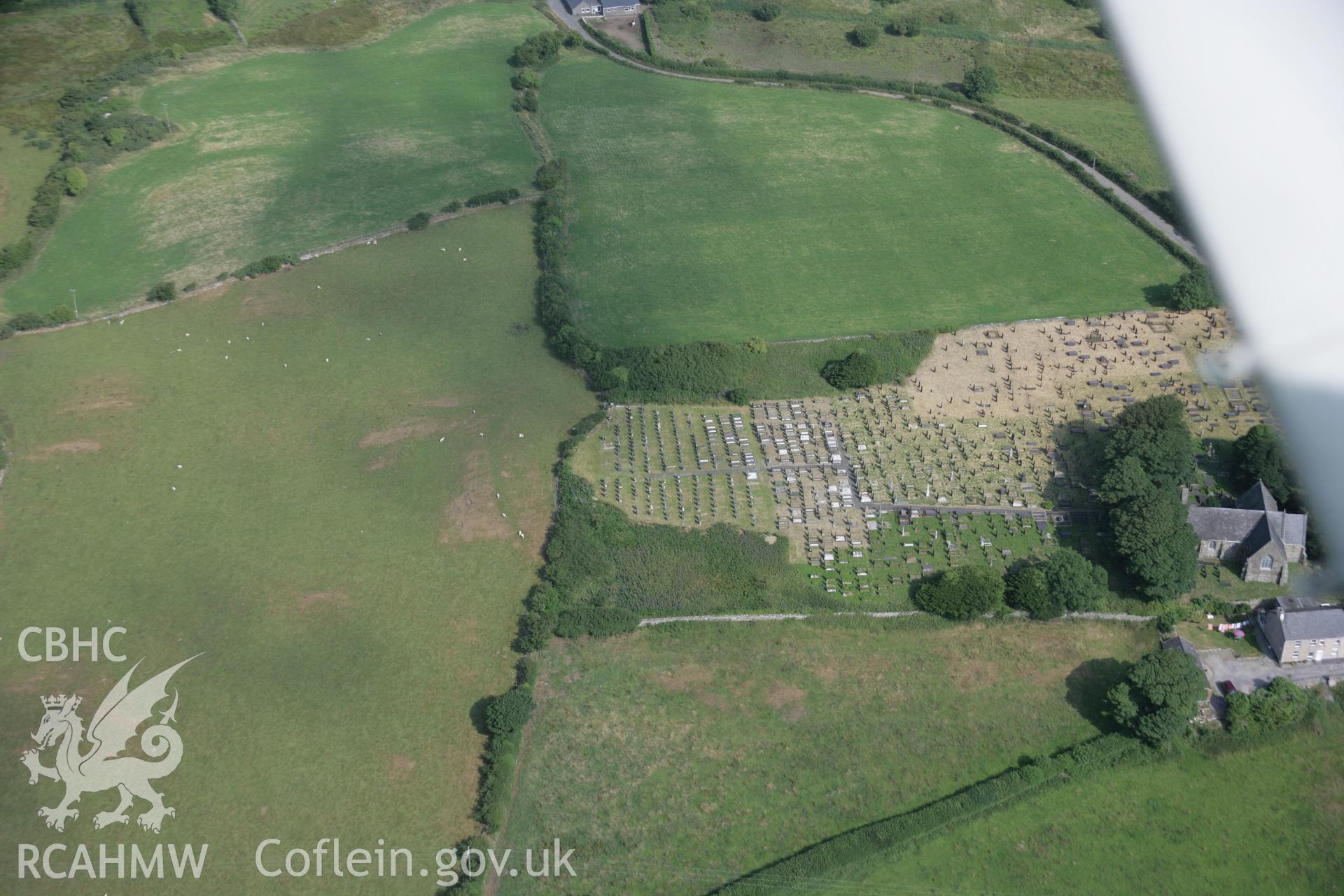 RCAHMW digital colour oblique photograph of Tyn-Llan-Uchaf Enclosure viewed from the south. Taken on 27/07/2005 by T.G. Driver.