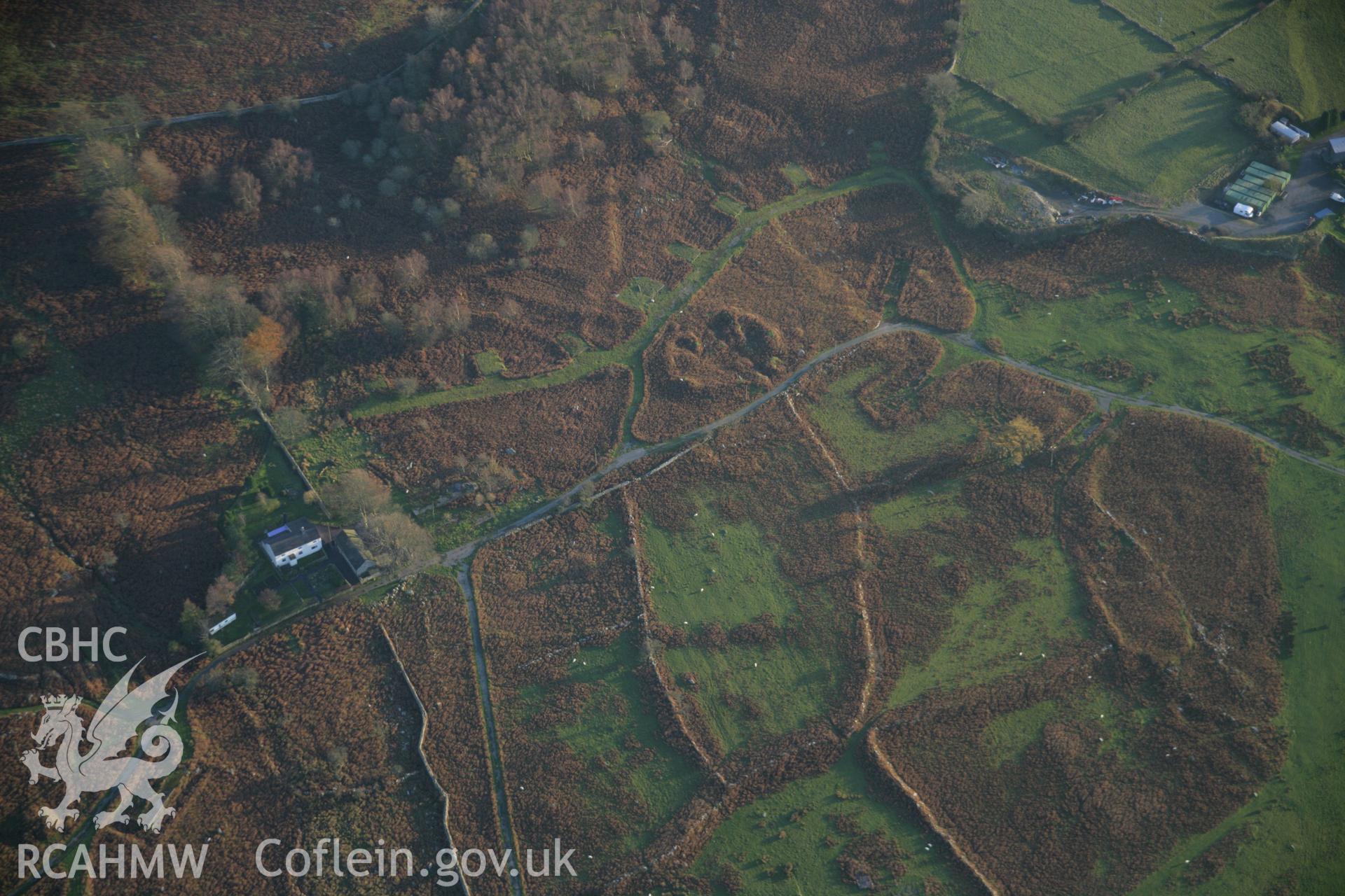 RCAHMW colour oblique aerial photograph of Cae'r Mynydd Enclosed Hut Group from the north-west. Taken on 21 November 2005 by Toby Driver