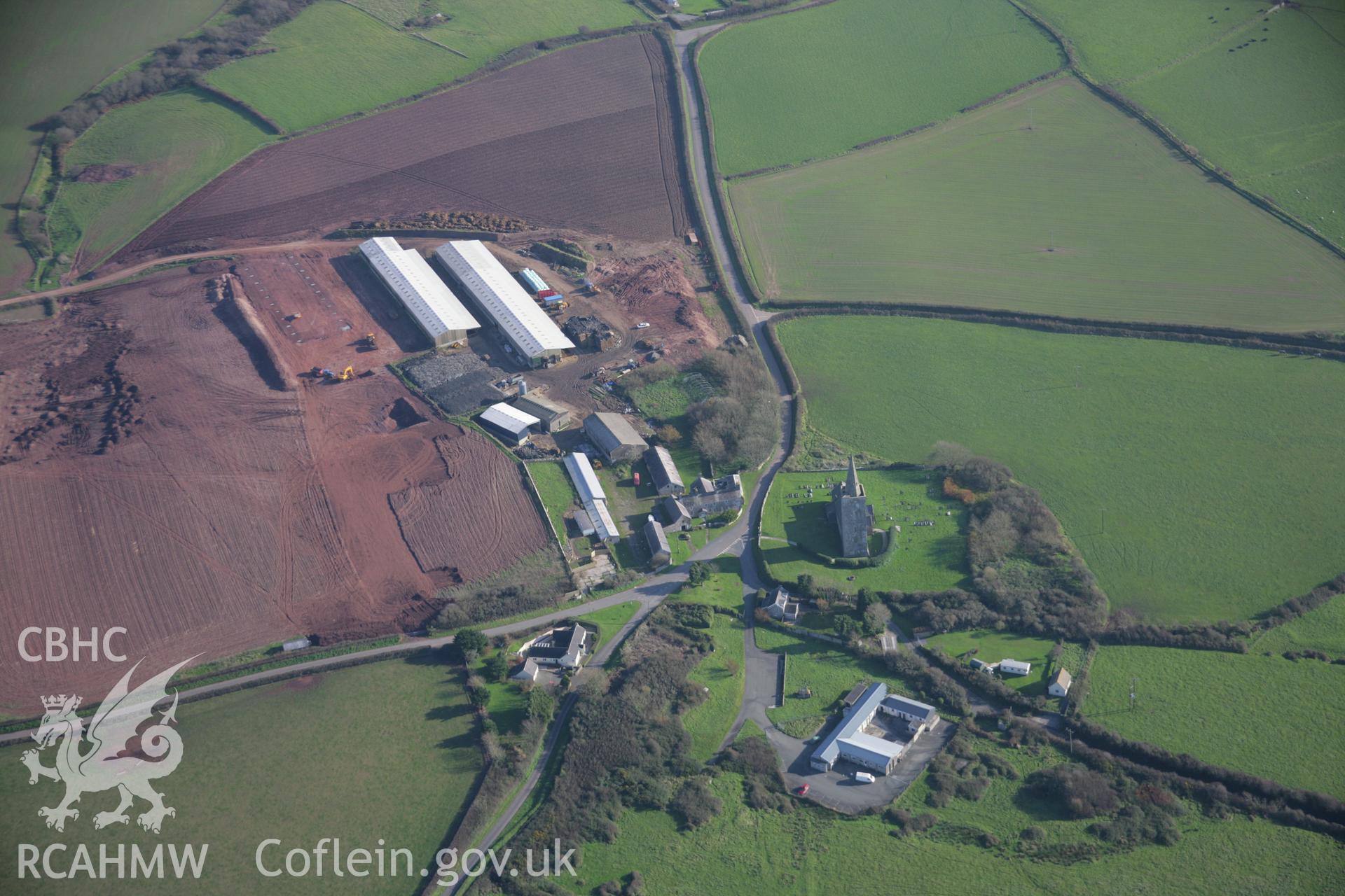 RCAHMW colour oblique aerial photograph of St Mary's Church, Warren, from the west showing farm development. Taken on 19 November 2005 by Toby Driver