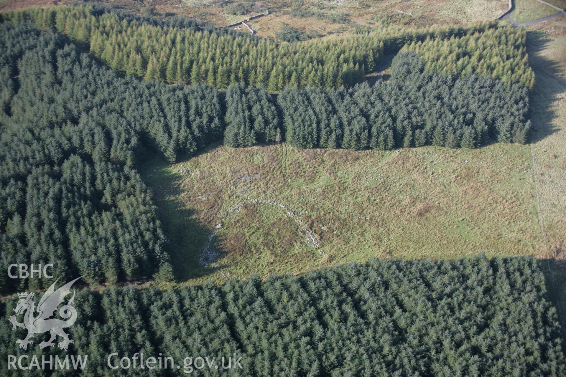 RCAHMW colour oblique aerial photograph of Cyfannedd Fawr Enclosure from the north-west.. Taken on 17 October 2005 by Toby Driver