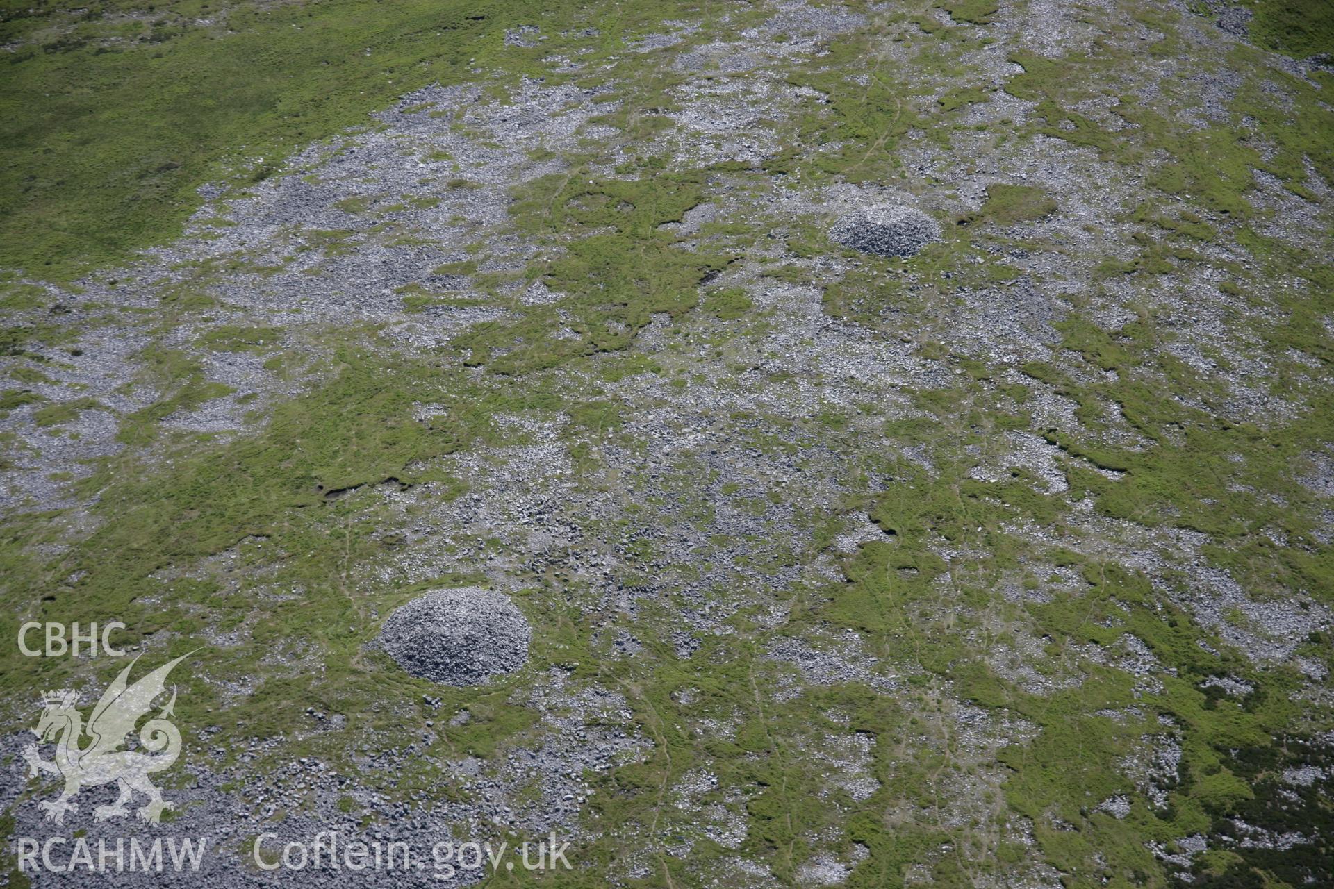 RCAHMW colour oblique aerial photograph of Tair Carn Uchaf Cairn B, Blaenpedol, looking south-west. Taken on 22 June 2005 by Toby Driver