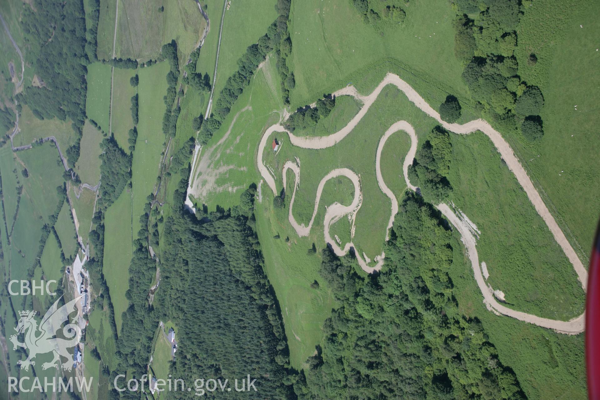 RCAHMW colour oblique aerial photograph of banks at Bola'r Allt Goch, near Strata Florida. Also showing a motocross track. Taken on 23 June 2005 by Toby Driver