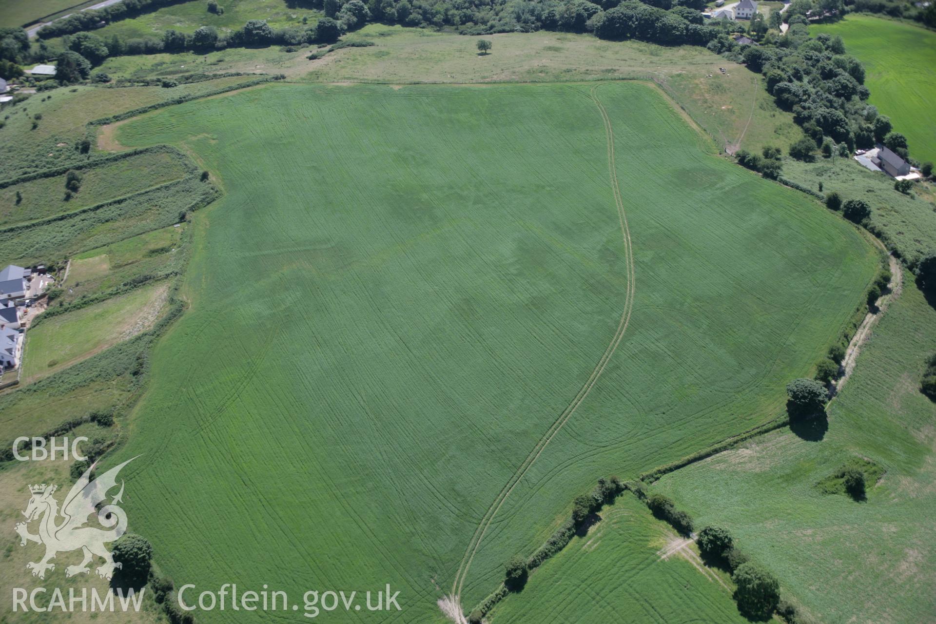 RCAHMW colour oblique aerial photograph of Penparc of emerging cropmark showing defended enclosure viewed from the north-east. Taken on 23 June 2005 by Toby Driver