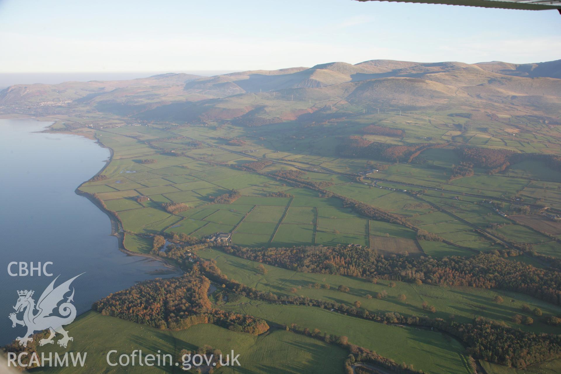 RCAHMW colour oblique aerial photograph of Penrhyn Castle Garden, Bangor, with coastal hills in panoramic view looking east from the park. Taken on 21 November 2005 by Toby Driver