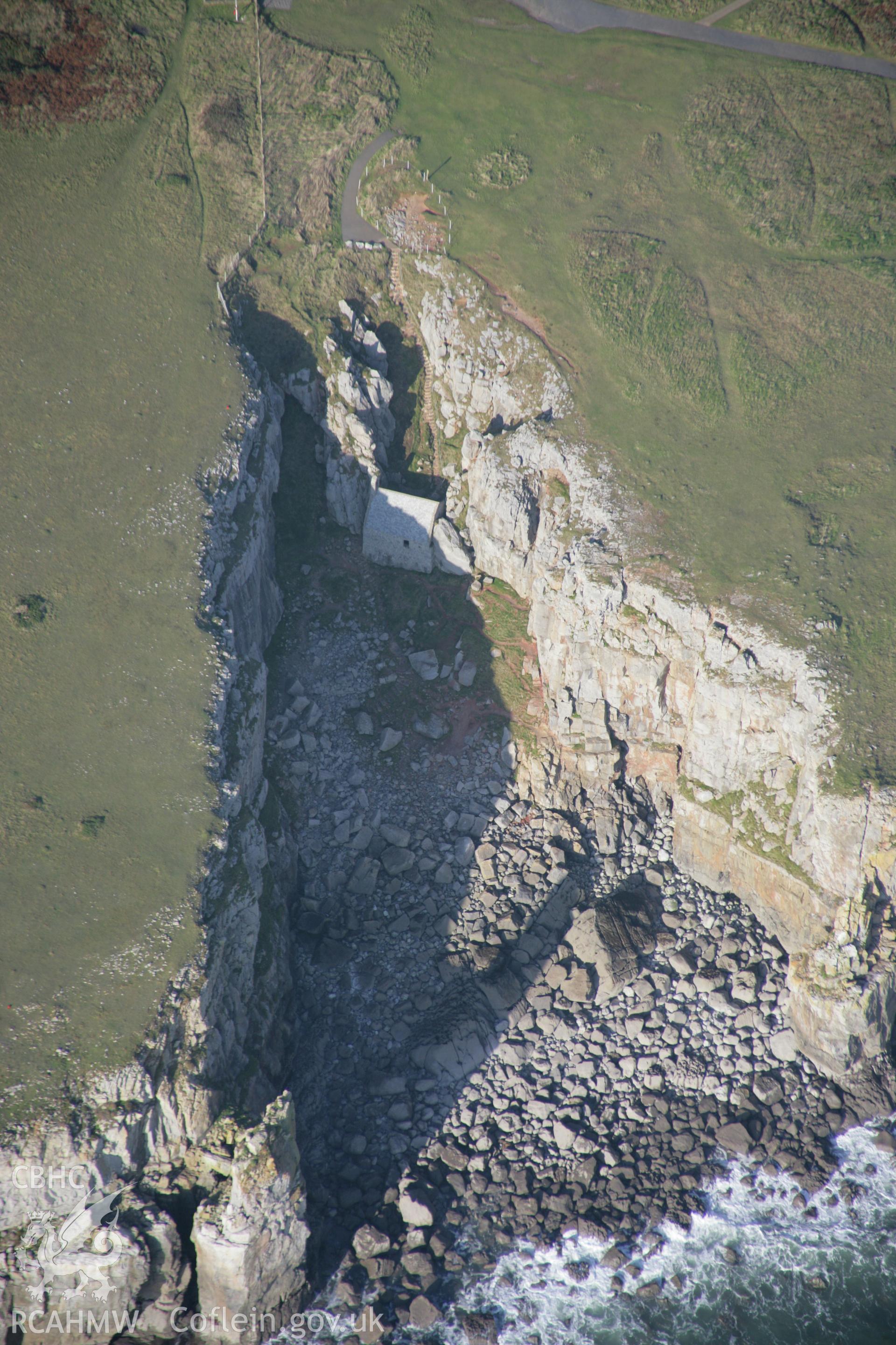 RCAHMW colour oblique aerial photograph of St Govan's Chapel and nearby well, from the south-east. Taken on 19 November 2005 by Toby Driver