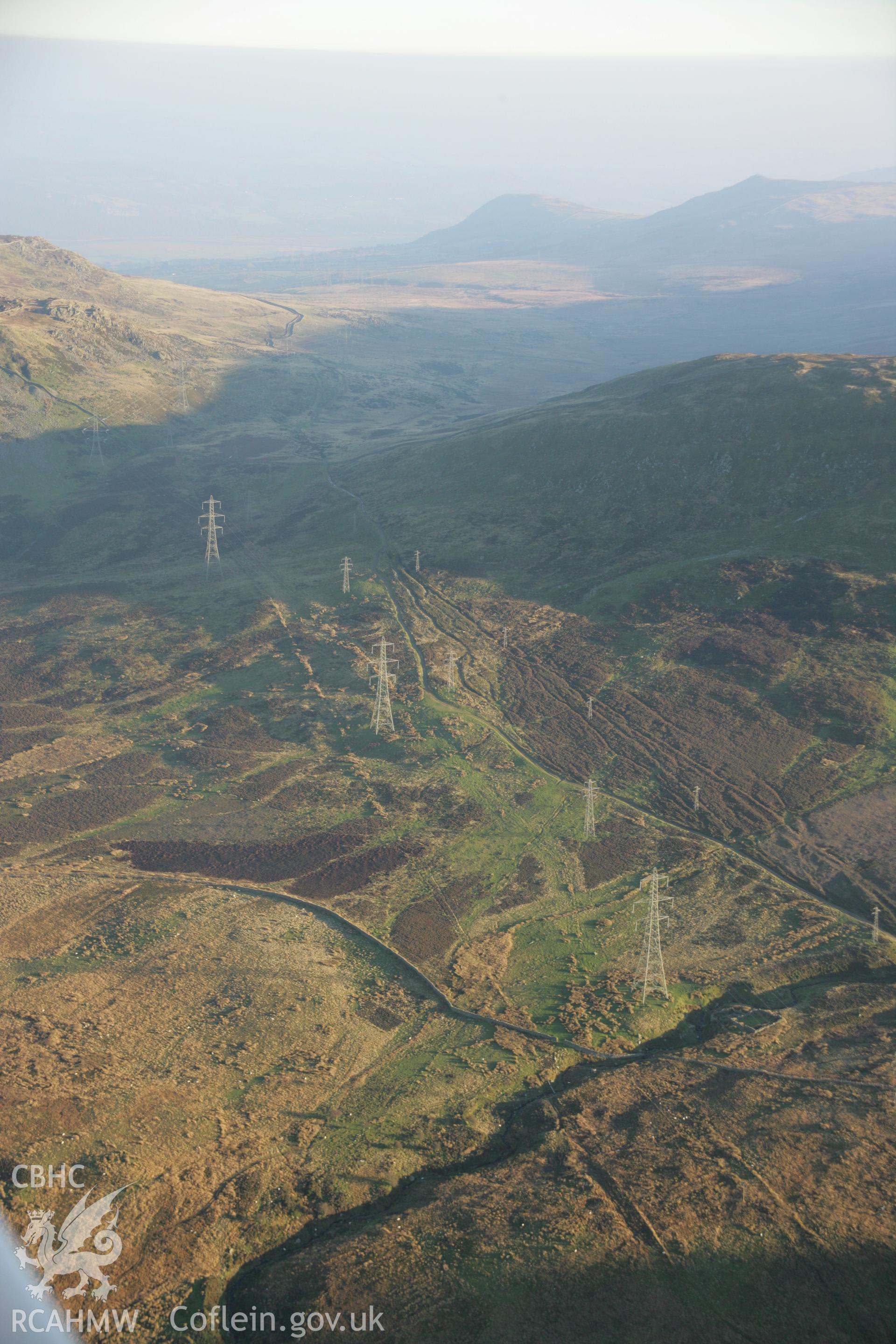 RCAHMW colour oblique aerial photograph of Bwlch-y-Ddeufaen Roman Road Segment showing the line of the road and braided trackways and pylons. Viewed from the north-west. Taken on 21 November 2005 by Toby Driver