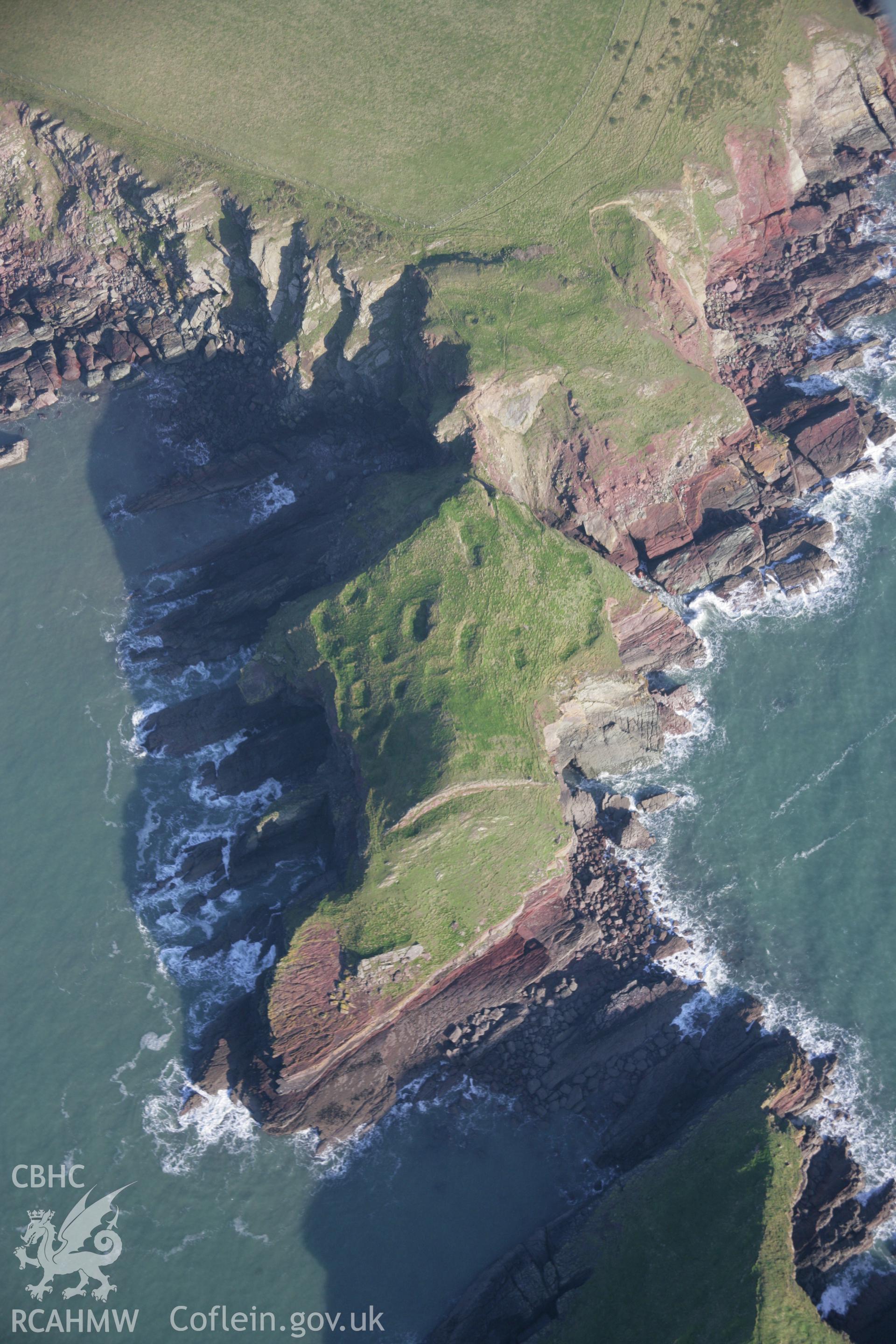 RCAHMW colour oblique aerial photograph of a promontory fort at Sheep Island viewed from south-west showing house platforms. Taken on 19 November 2005 by Toby Driver