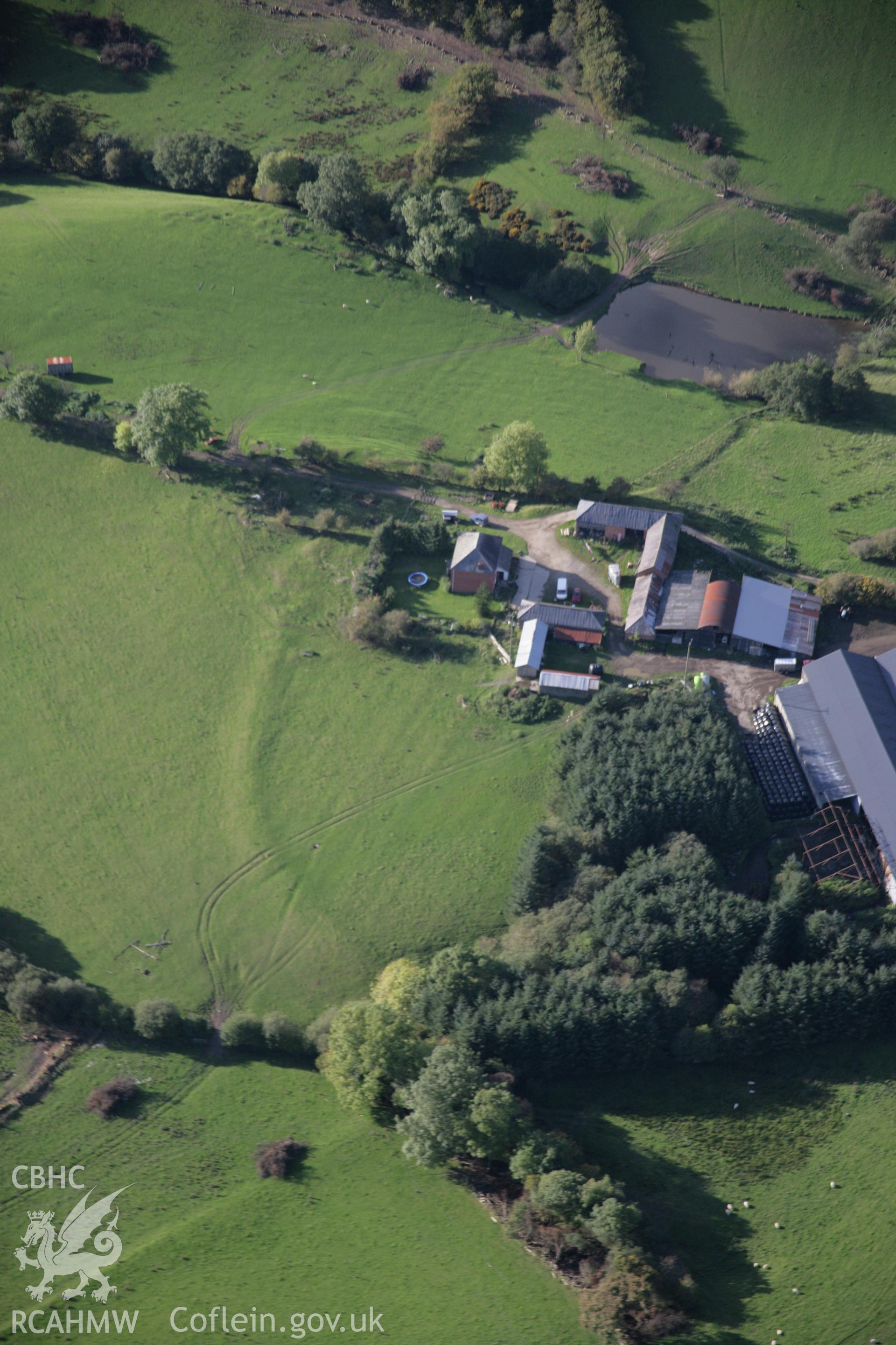 RCAHMW colour oblique aerial photograph of Cwm-Cefn-y-Gaer Farmstead, west of Heartsease, with the earthwork of a possible fort or relict field boundary. Viewed from the south-east. Taken on 13 October 2005 by Toby Driver