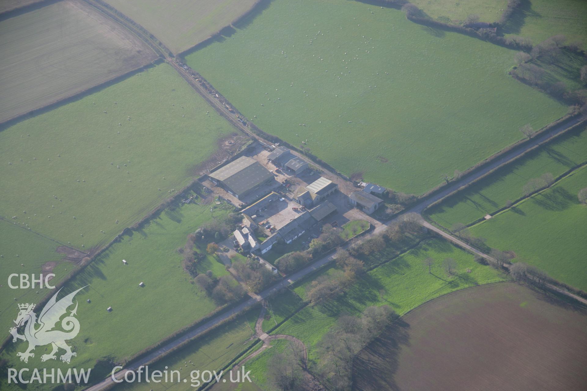 RCAHMW colour oblique aerial photograph of The Love Stone, Loveston. A distant view from the north-east showing a farm. Taken on 19 November 2005 by Toby Driver