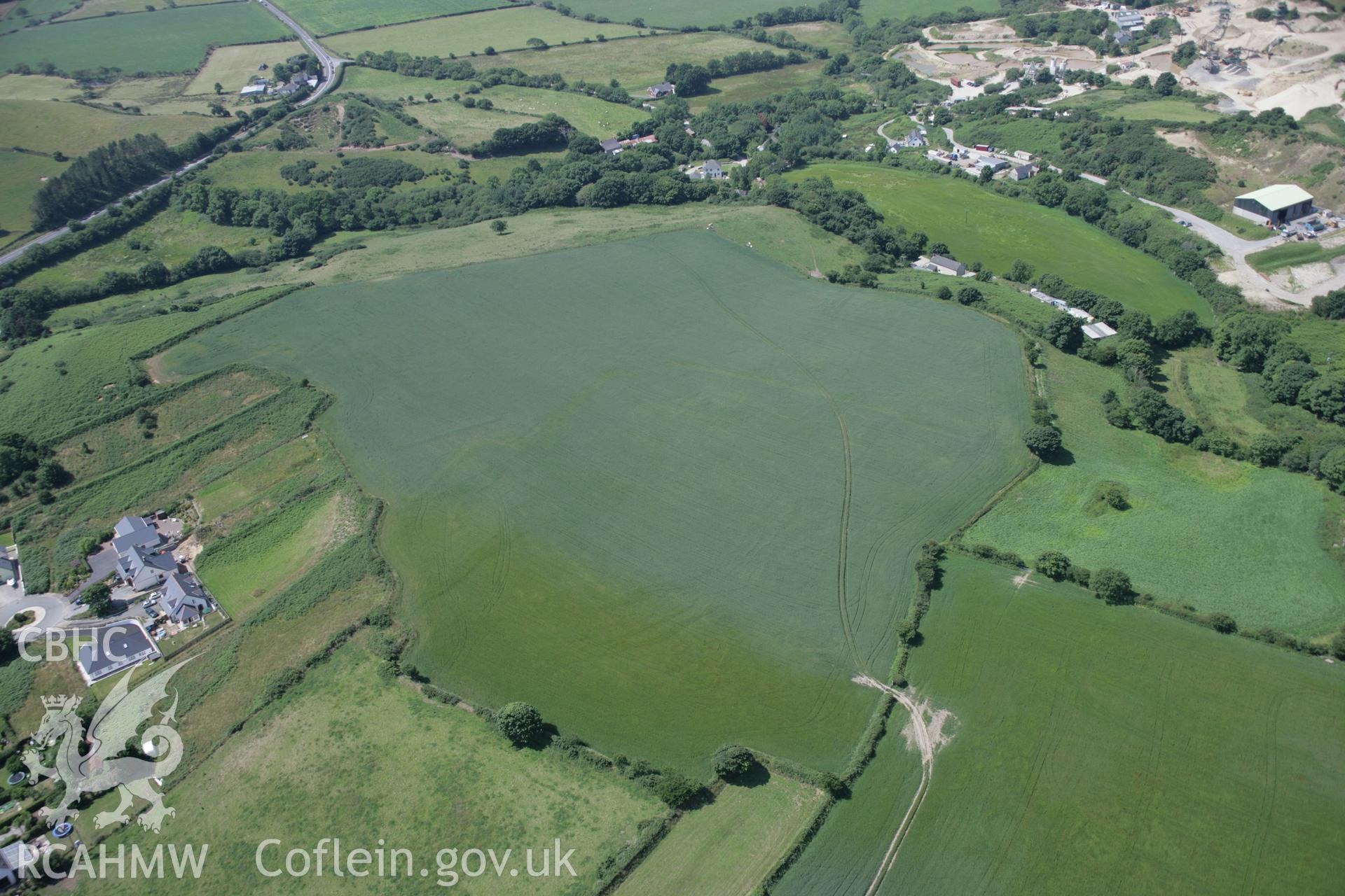 RCAHMW colour oblique aerial photograph of Penparc of emerging cropmark showing defended enclosure viewed from the south-east. Taken on 11 July 2005 by Toby Driver