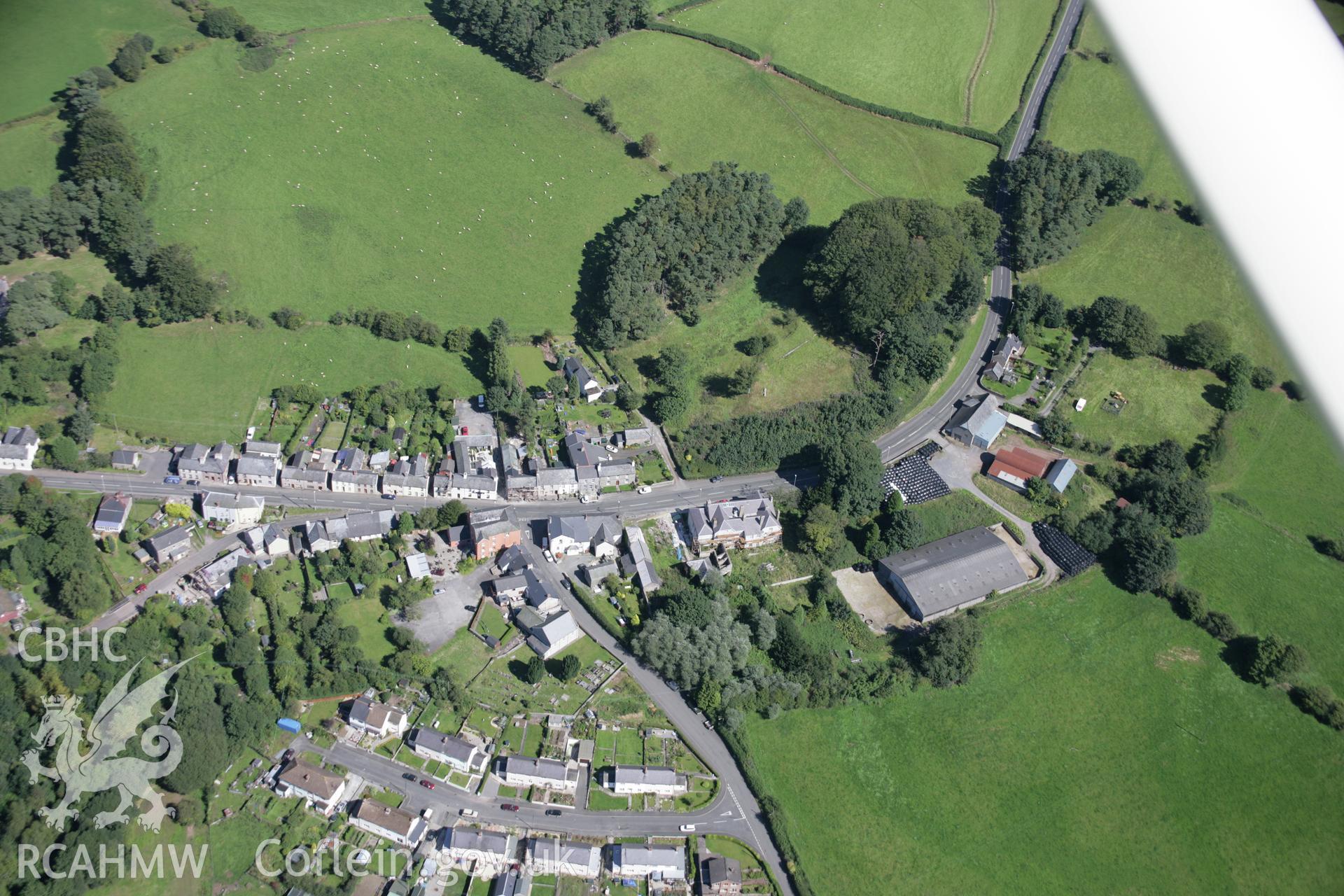 RCAHMW colour oblique aerial photograph of Trecastle Motte and the village from the south. Taken on 02 September 2005 by Toby Driver