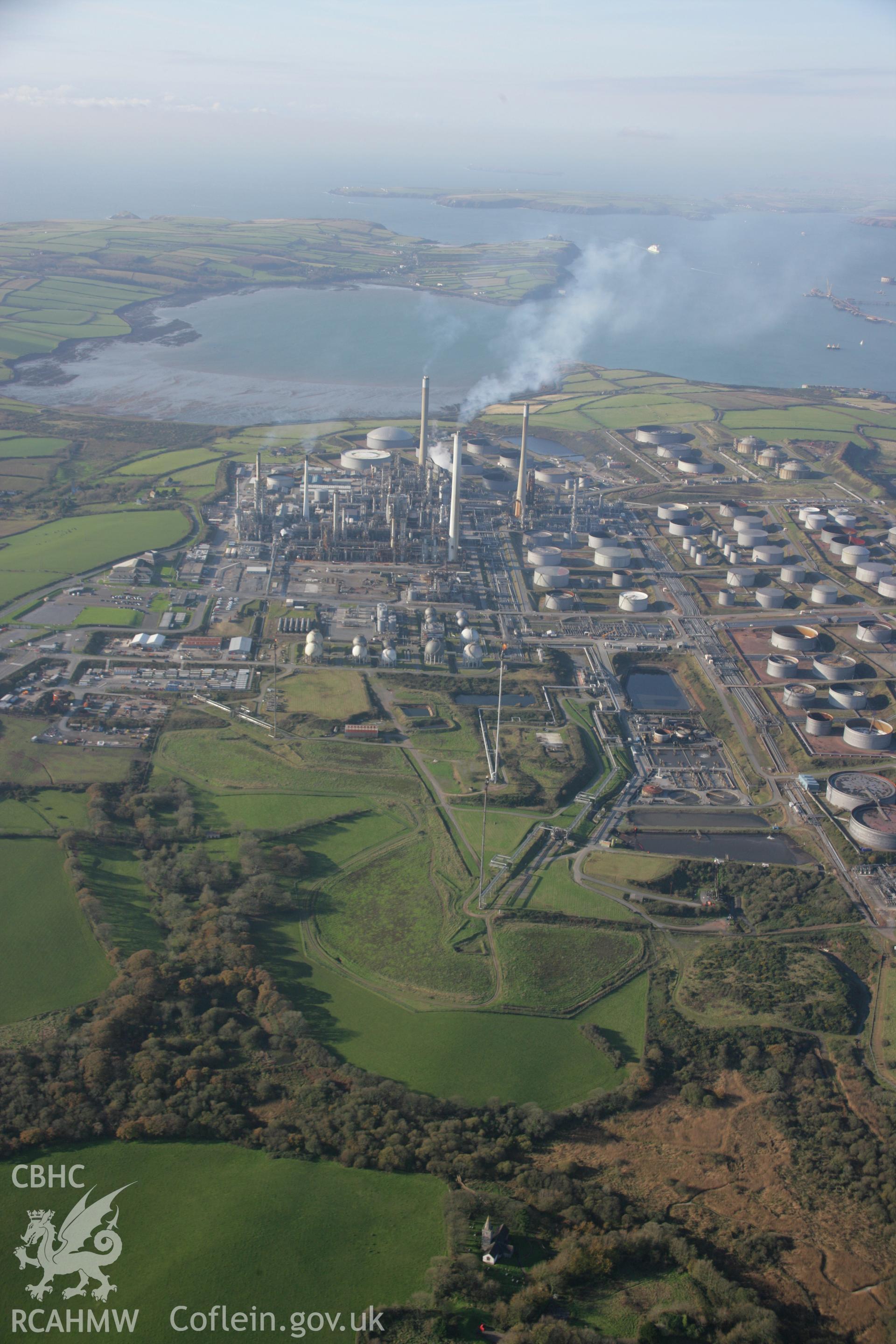 RCAHMW colour oblique aerial photograph of Angle Bay BP Oil Terminal and Pumping Station, Popton, Milford Haven. Viewed from the east with St Mary's Church, Pwllcrochan. Taken on 19 November 2005 by Toby Driver