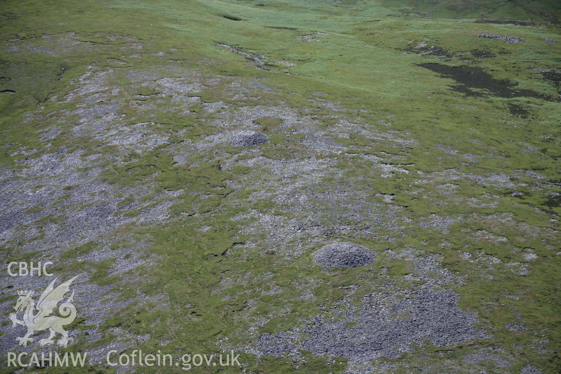 RCAHMW colour oblique aerial photograph of Tair Carn Uchaf Cairn B, Blaenpedol, looking south-west. Taken on 22 June 2005 by Toby Driver