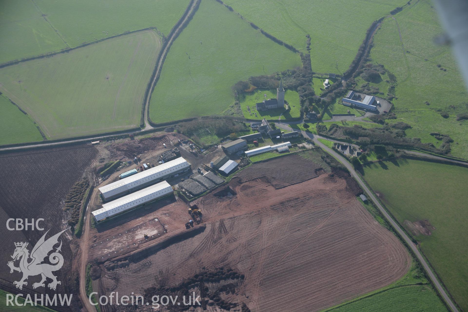 RCAHMW colour oblique aerial photograph of St Mary's Church, Warren, from the west showing farm development. Taken on 19 November 2005 by Toby Driver