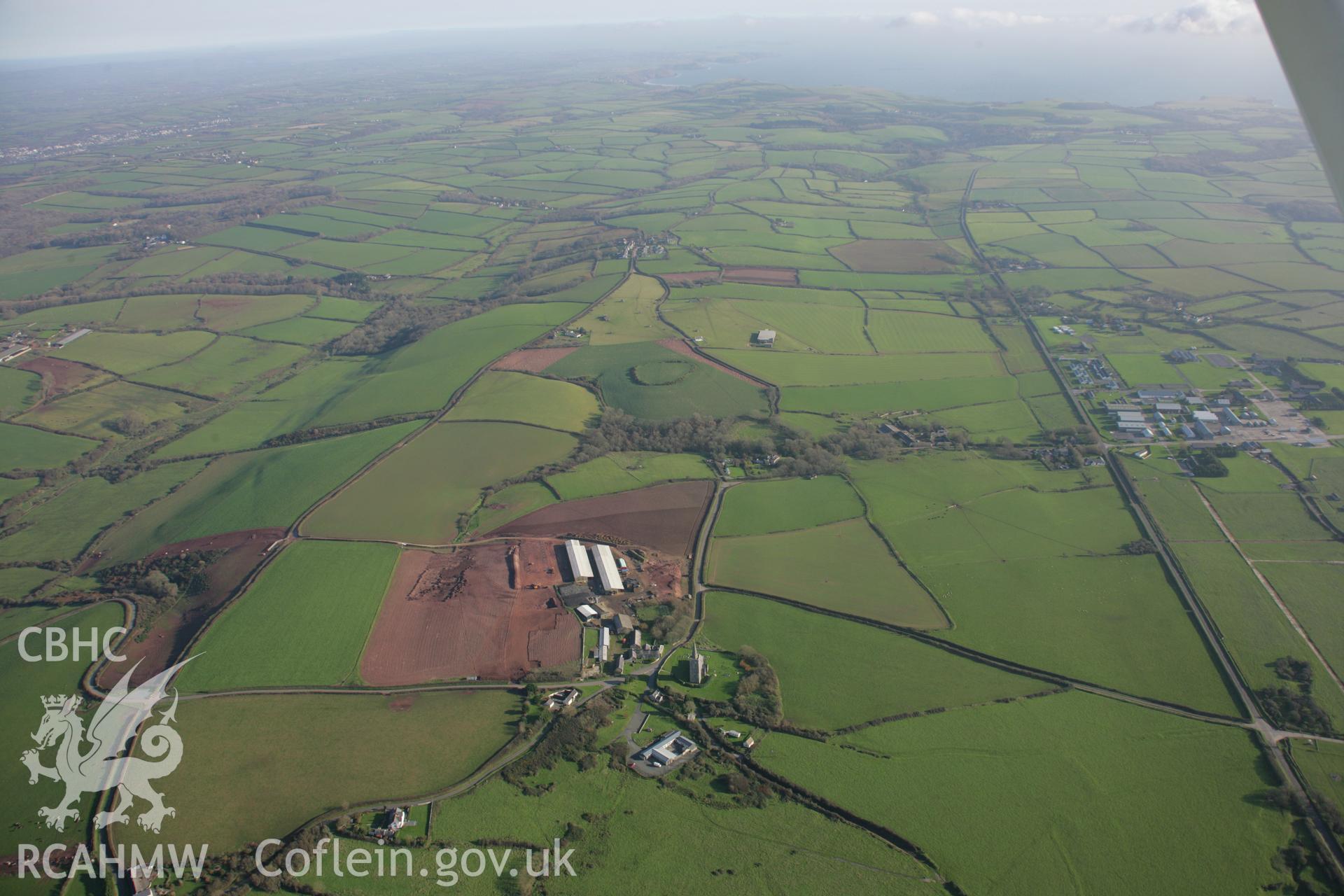 RCAHMW colour oblique aerial photograph of St Mary's Church, Warren. A panoramic landscape view looking east. Taken on 19 November 2005 by Toby Driver