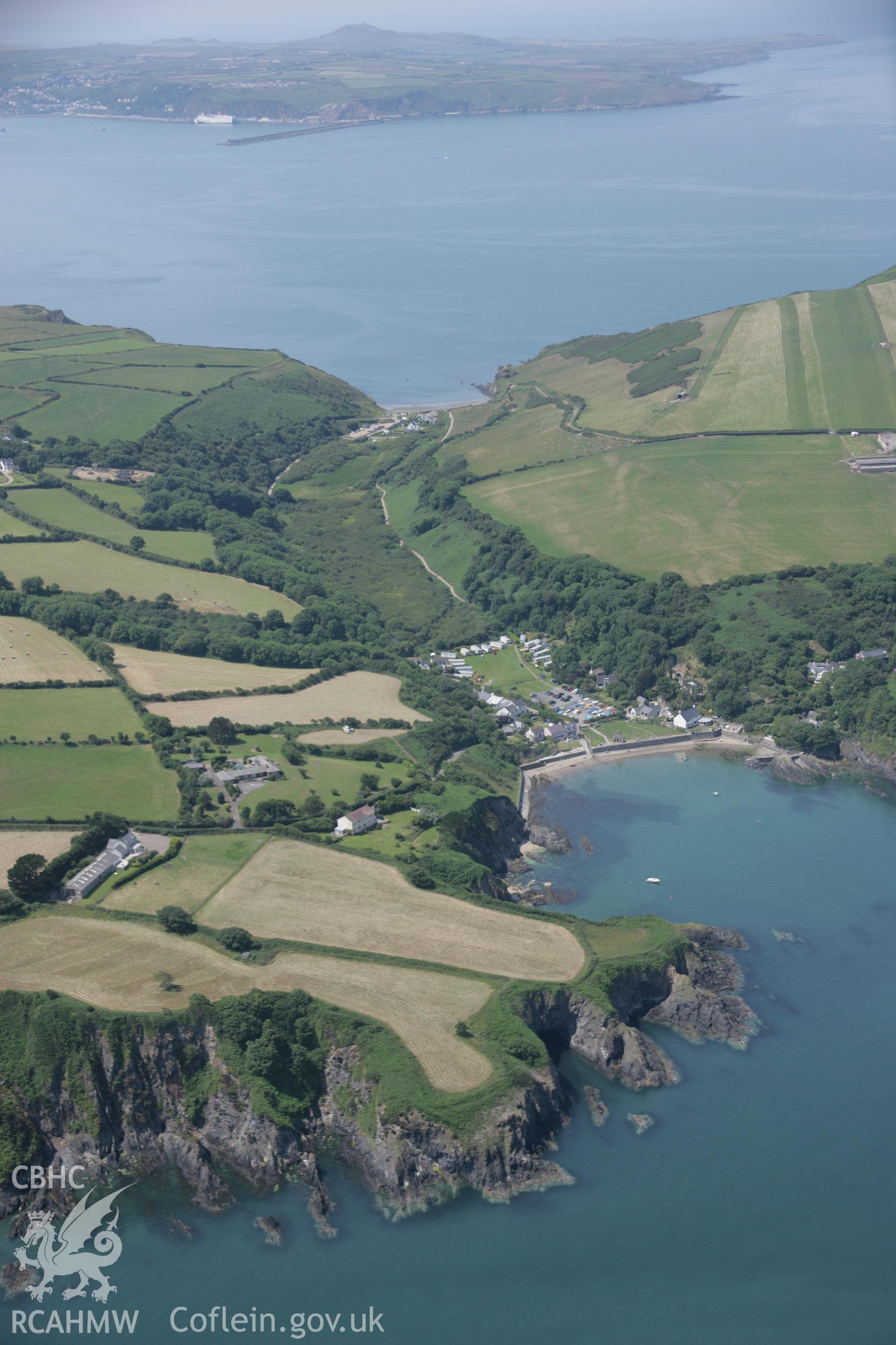 RCAHMW colour oblique aerial photograph of Cwm-Yr-Eglwys Harbour, Dinas Head viewed from the east. Taken on 11 July 2005 by Toby Driver