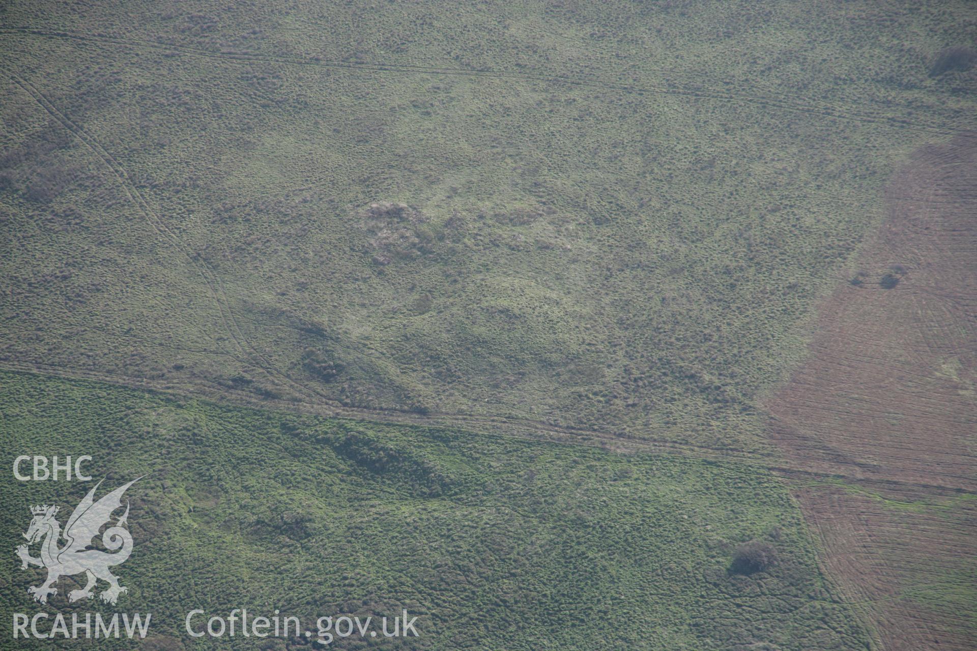 RCAHMW colour oblique aerial photograph of Brownslade Round Barrow and early medieval cemetery, Castlemartin, in wide landscape view from the north. Taken on 19 November 2005 by Toby Driver