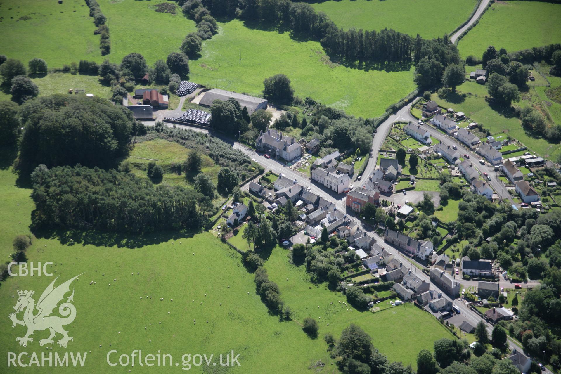 RCAHMW colour oblique aerial photograph of Trecastle Motte and the village from the north-west. Taken on 02 September 2005 by Toby Driver