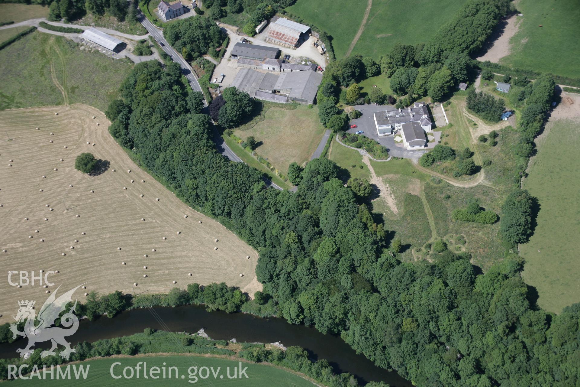 RCAHMW colour oblique aerial photograph of Llwynduris Castle Mound, heavily wooded motte, viewed from the south. Taken on 23 June 2005 by Toby Driver