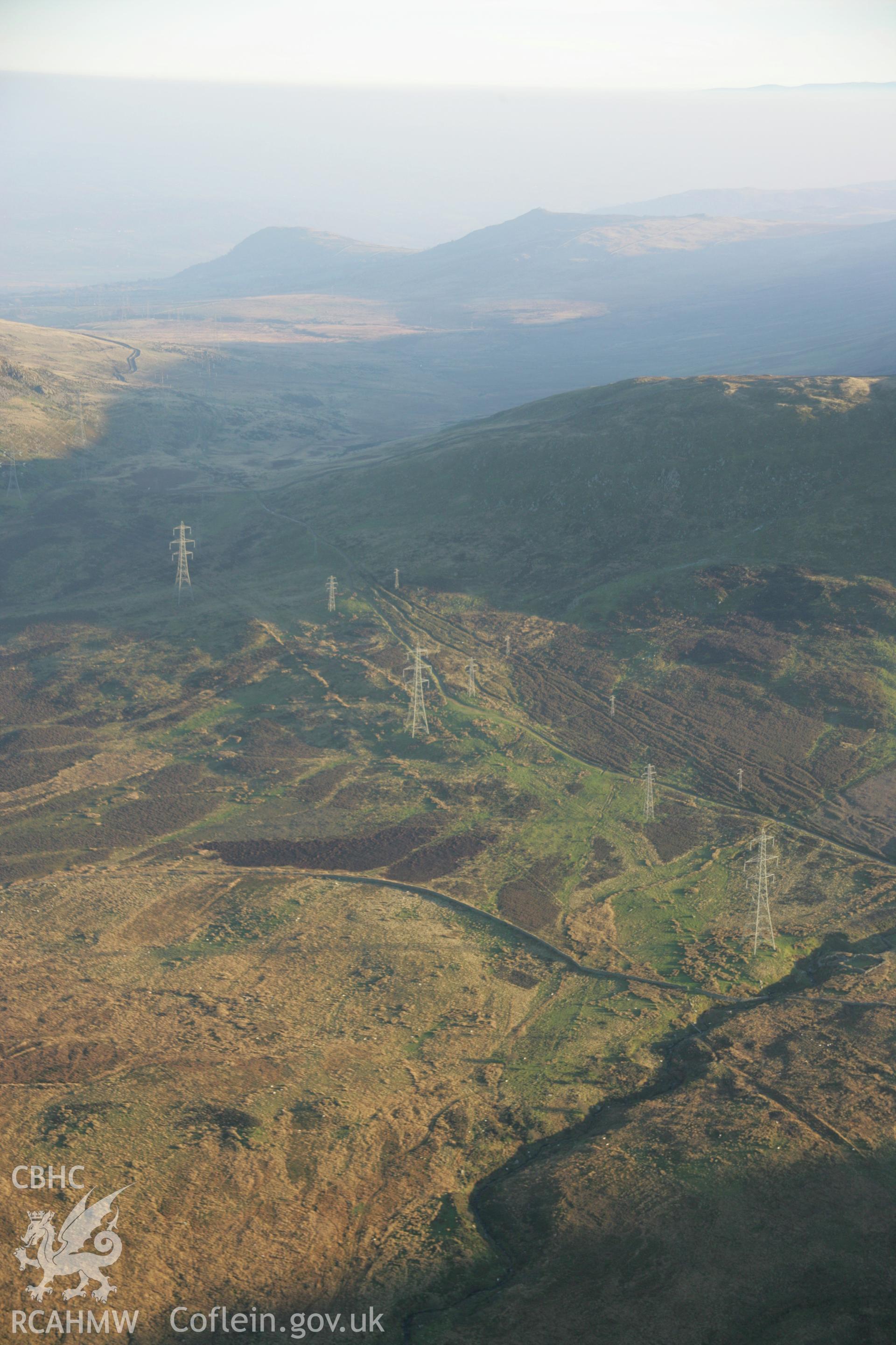 RCAHMW colour oblique aerial photograph of Bwlch-y-Ddeufaen Roman Road Segment showing the line of the road and braided trackways and pylons. Viewed from the north-west. Taken on 21 November 2005 by Toby Driver