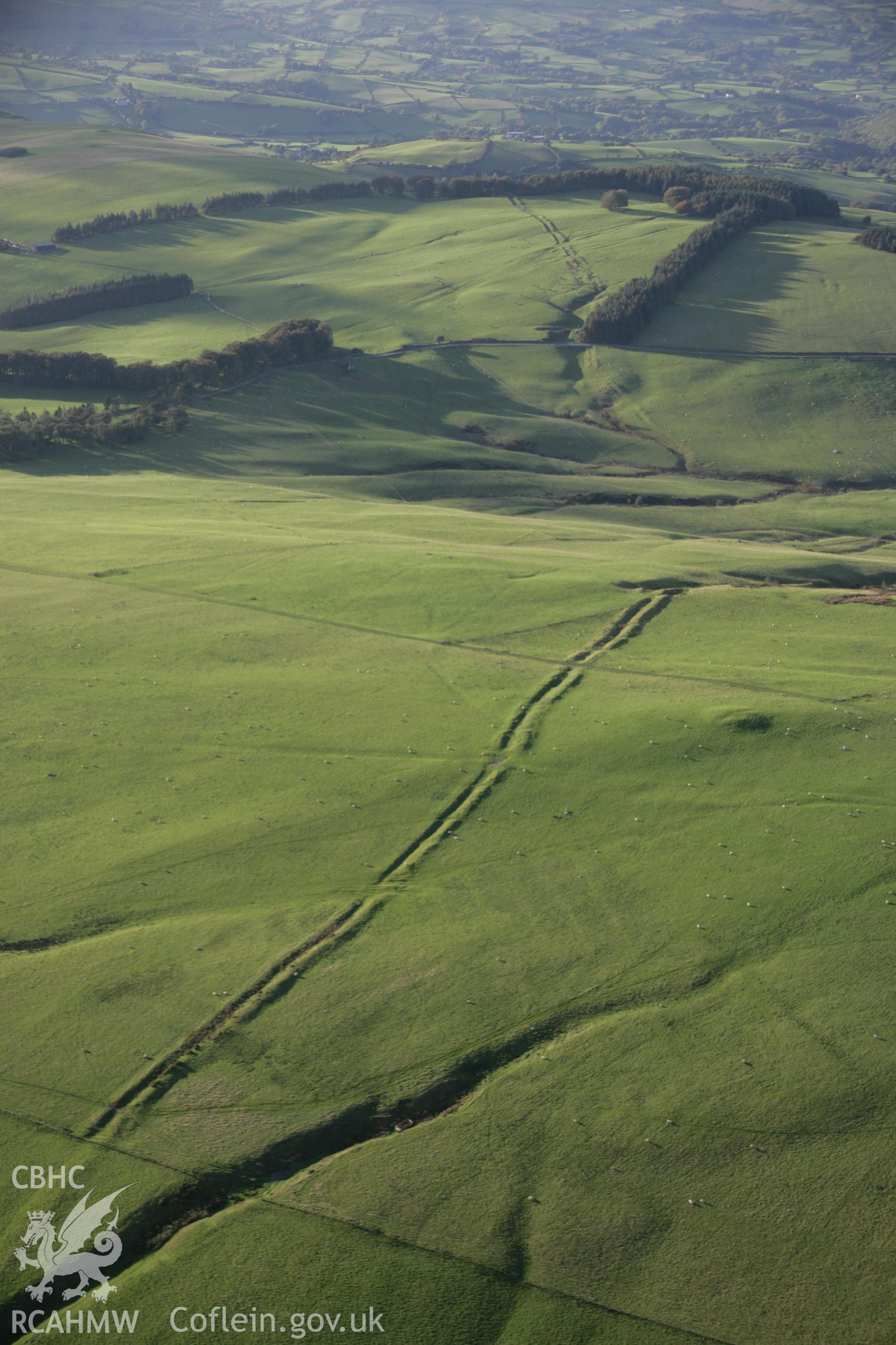 RCAHMW colour oblique aerial photograph of Two Tumps Dyke II and nearby barrows, viewed looking north-west. Taken on 13 October 2005 by Toby Driver