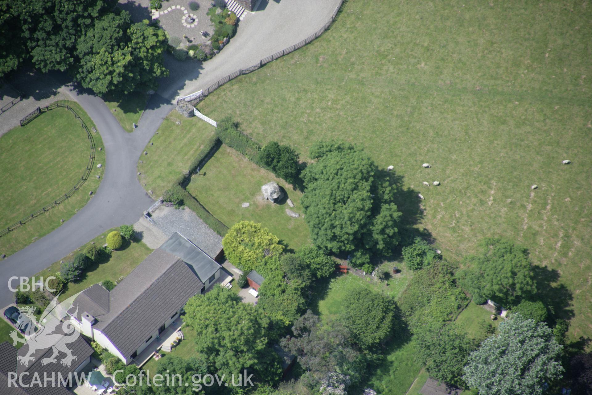 RCAHMW colour oblique aerial photograph of Carreg Coetan Arthur. A view from the east with nearby houses. Taken on 11 July 2005 by Toby Driver