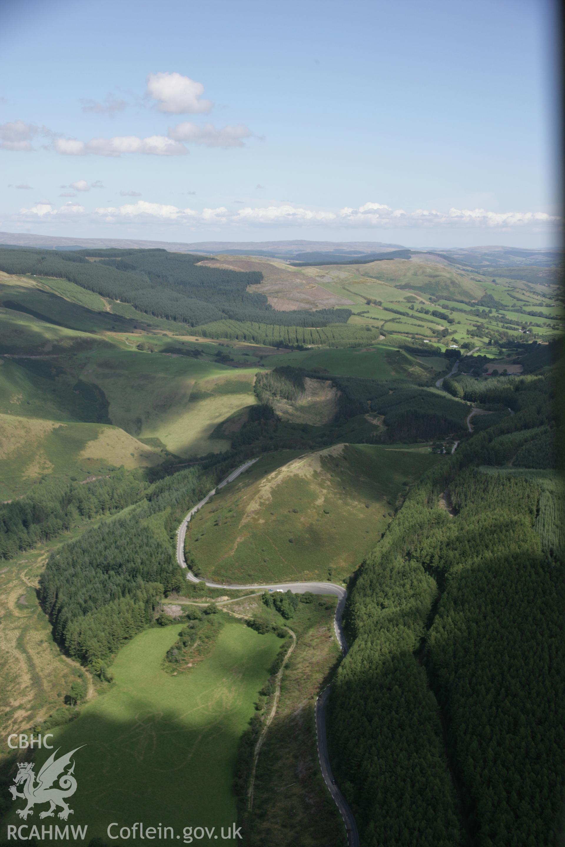 RCAHMW colour oblique aerial photograph of Sugar Loaf Hillfort. A long landscape view from the south-west. Taken on 02 September 2005 by Toby Driver