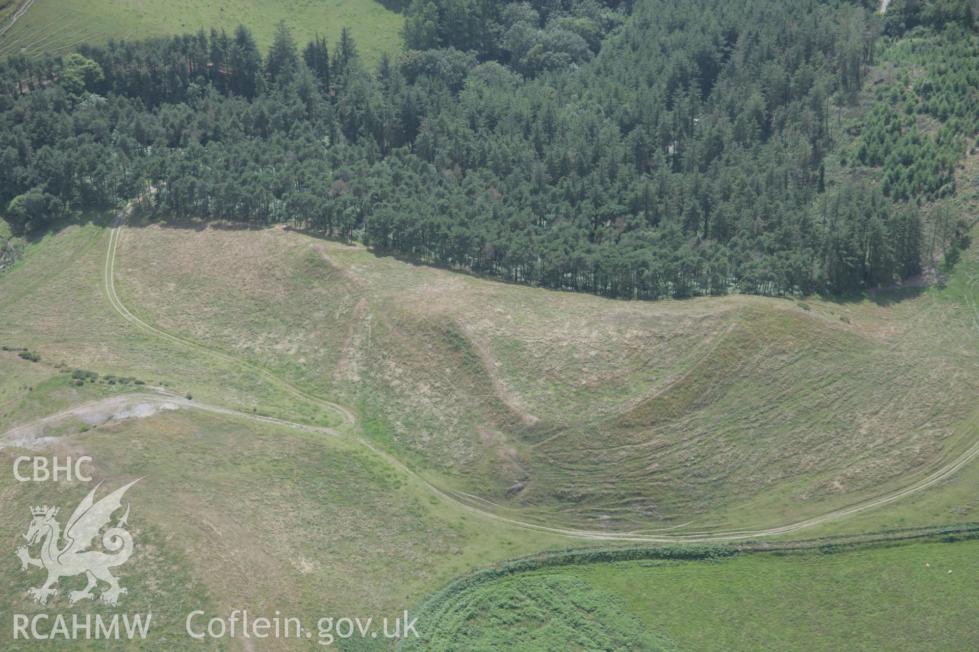 RCAHMW digital colour oblique photograph of Cnwc y Bugail Iron Age Hillfort from the east. Taken on 18/07/2005 by T.G. Driver.