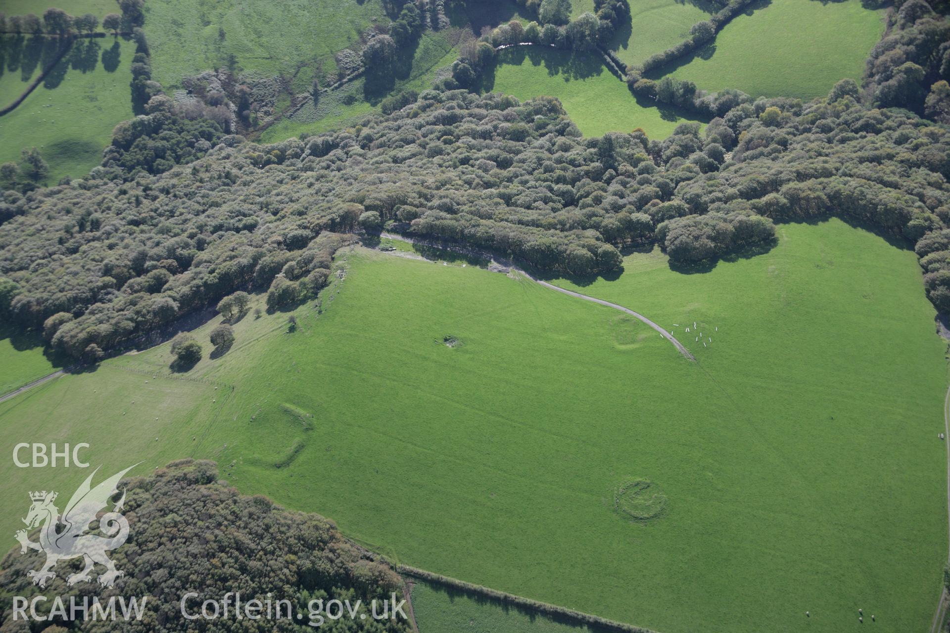 RCAHMW colour oblique aerial photograph of Coed Ty Mawr Enclosure and Cefn Ty Mawr Cairn from the north-east. Taken on 13 October 2005 by Toby Driver