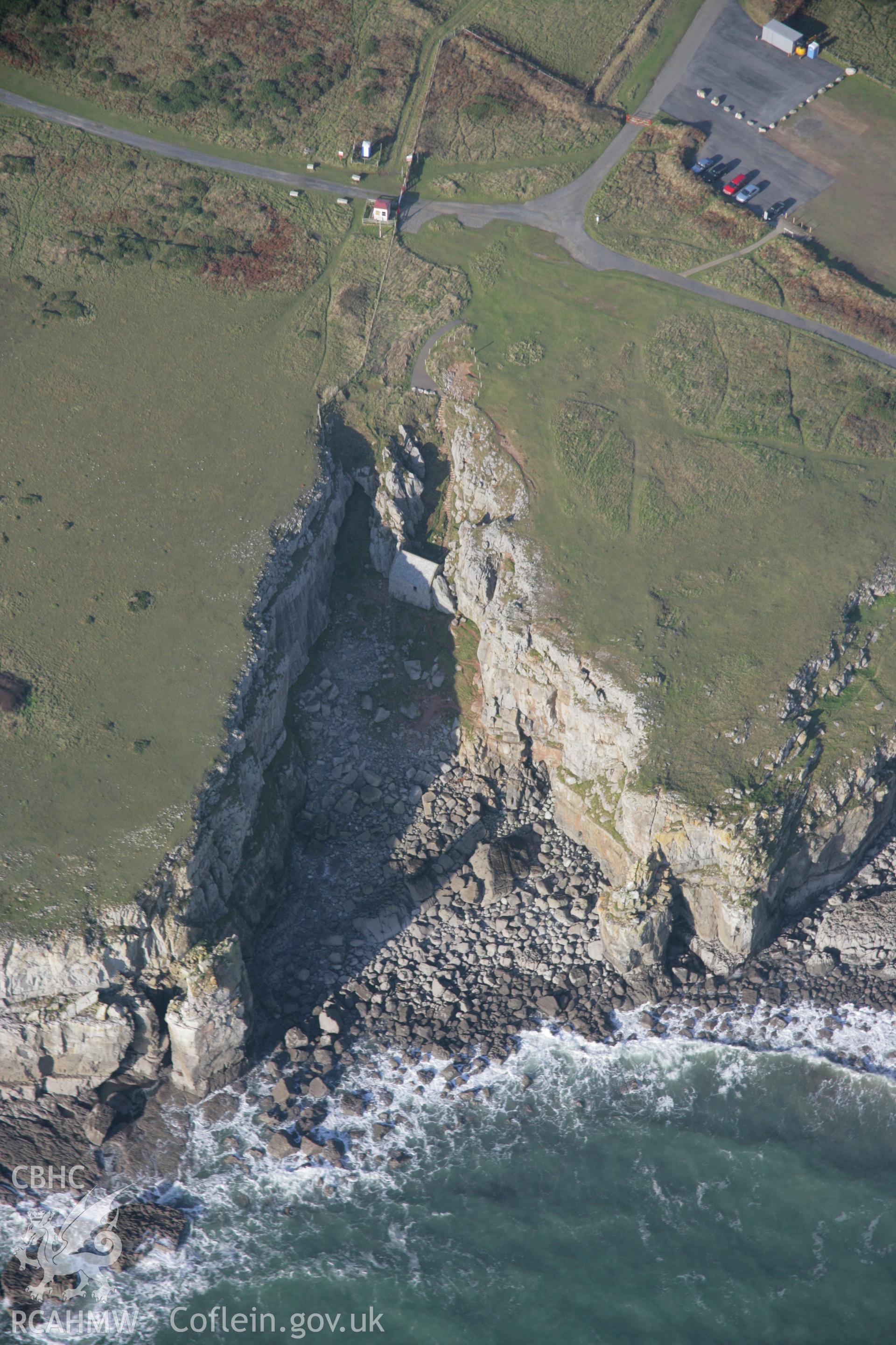 RCAHMW colour oblique aerial photograph of St Govan's Chapel and nearby well, from the south-east. Taken on 19 November 2005 by Toby Driver