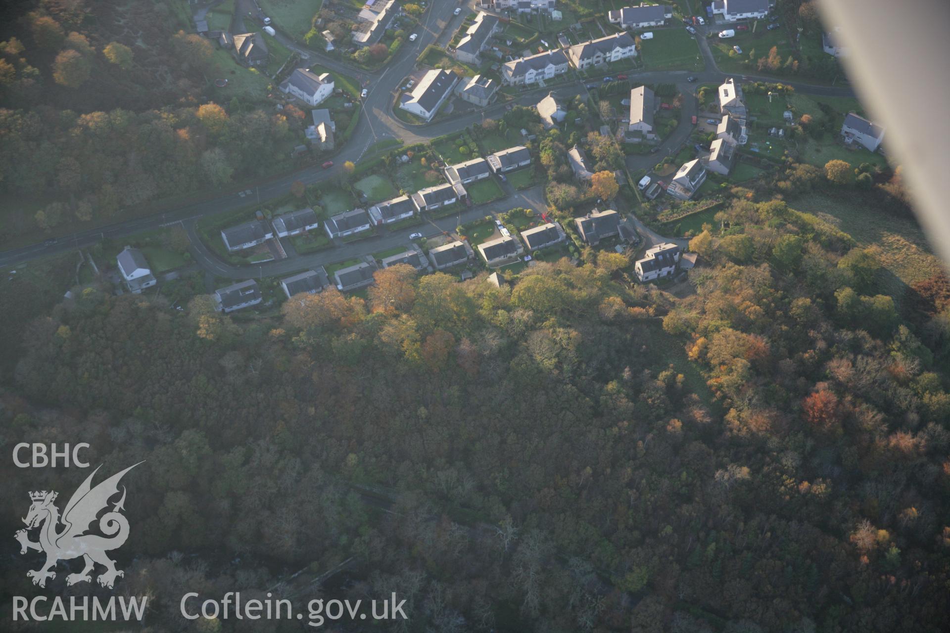 RCAHMW colour oblique aerial photograph of Pen Dinas Camp, shown in wooded view from the east. Taken on 21 November 2005 by Toby Driver