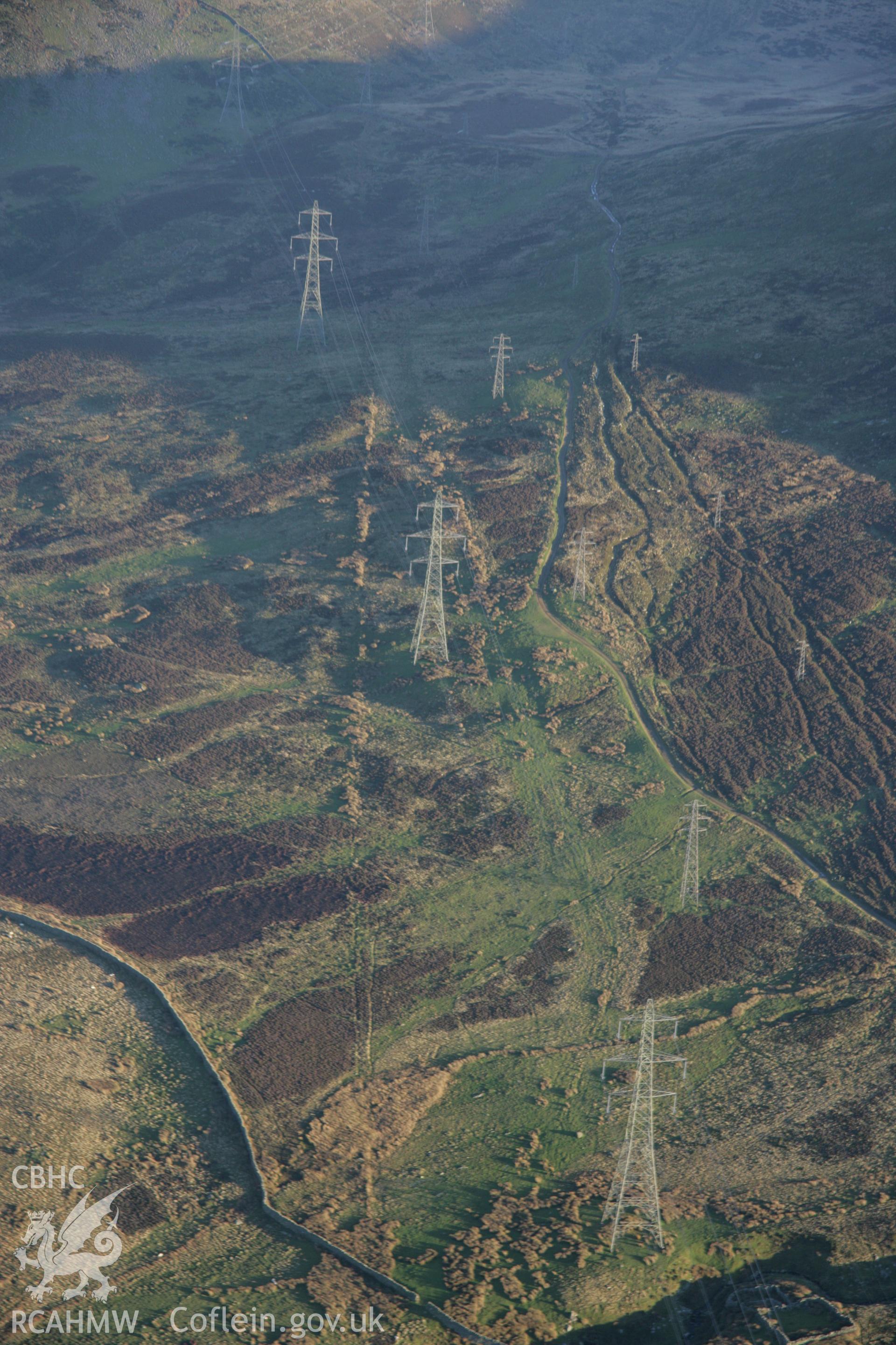 RCAHMW colour oblique aerial photograph of Bwlch-y-Ddeufaen Roman Road Segment showing the line of the road and braided trackways and pylons. Viewed from the west. Taken on 21 November 2005 by Toby Driver