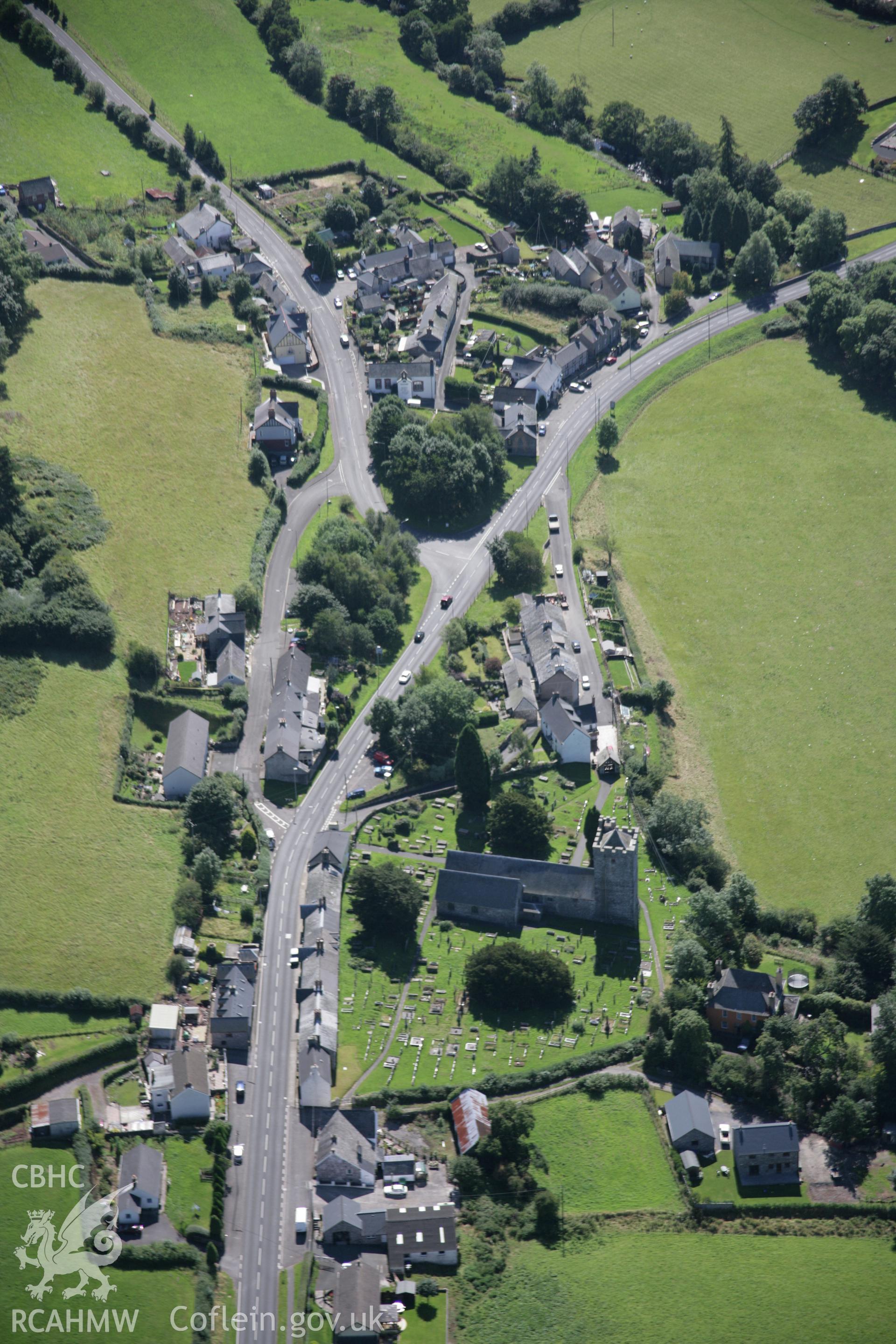 RCAHMW colour oblique aerial photograph of St Cynog's Church, Defynnog Vilage, in general view from the north. Taken on 02 September 2005 by Toby Driver