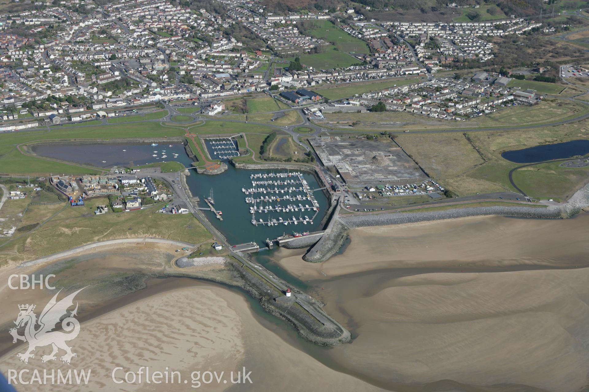 RCAHMW colour oblique photograph of Pembrey New Harbour, with Burry Port Lighthouse and Iron Canal Boats. Taken by Toby Driver on 04/03/2008.