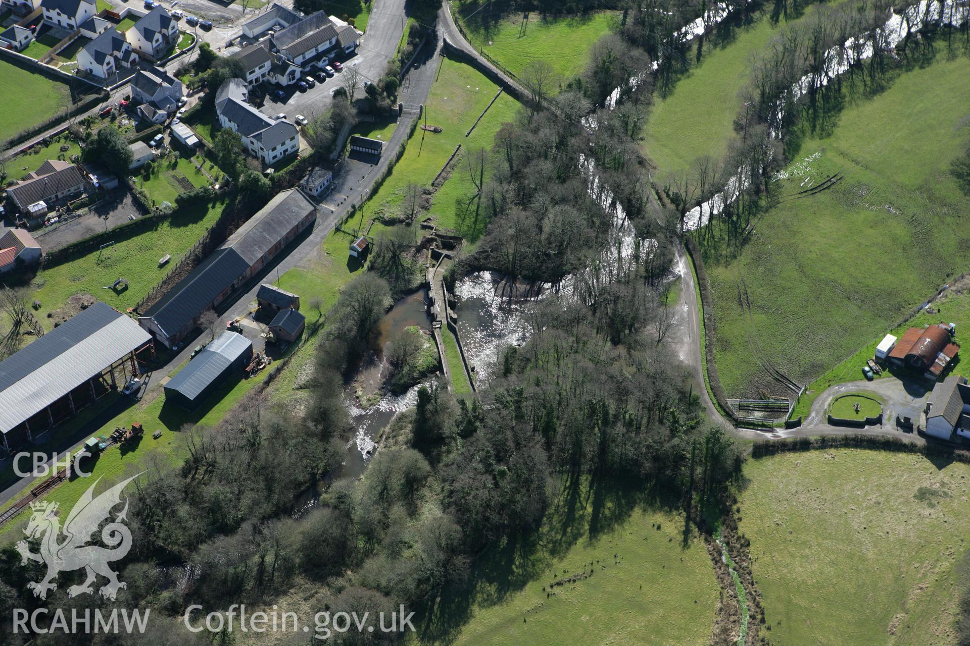 RCAHMW colour oblique photograph of Kidwelly Tinplate Works (Kidwelly Industrial Museum), showing sluices and dam. Taken by Toby Driver on 04/03/2008.