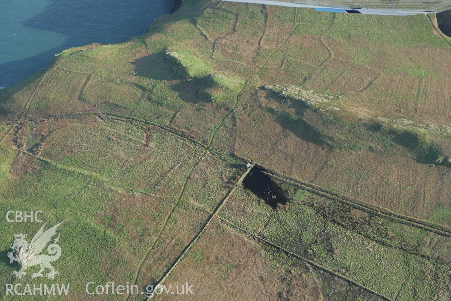 RCAHMW colour oblique photograph of Skomer Island, Hut groups 17, 18, 19 and 44, view from north. Taken by Toby Driver on 04/03/2008.