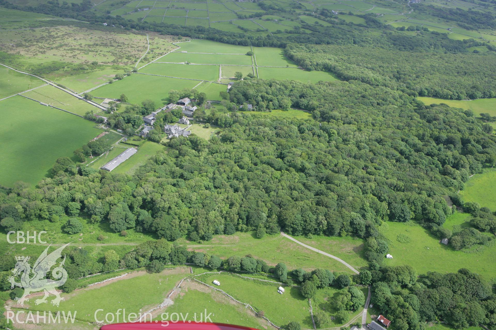 RCAHMW colour oblique photograph of landscape looking east over Cors-y-Gedol Hall towards Cors-y-Gedol Settlements and Field System and Burial Chamber. Taken by Toby Driver on 13/06/2008.