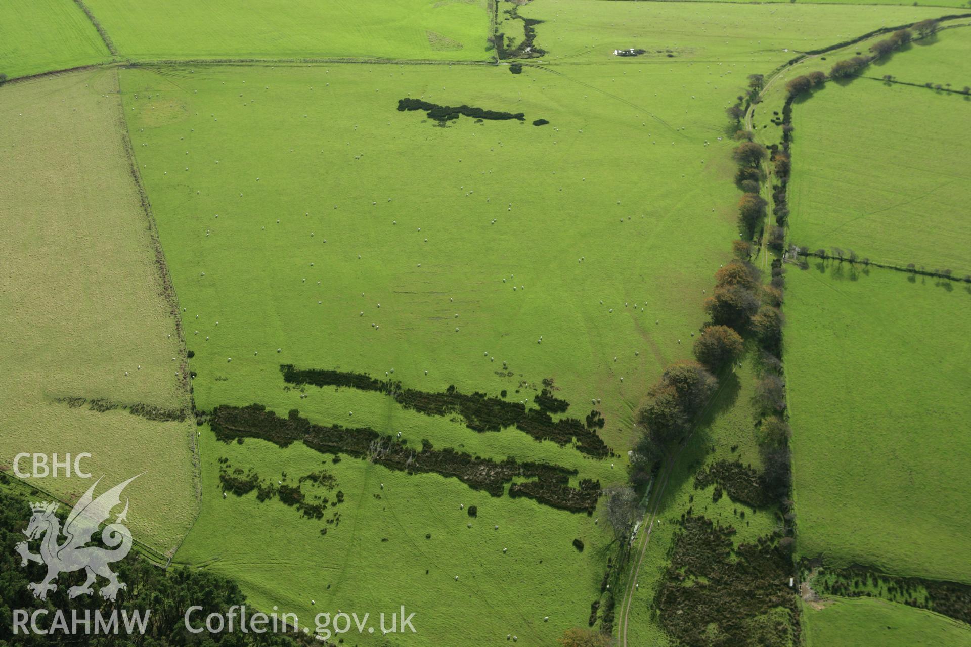 RCAHMW colour oblique photograph of earthworks to the east of Ton Mawr Enclosure. Taken by Toby Driver on 16/10/2008.